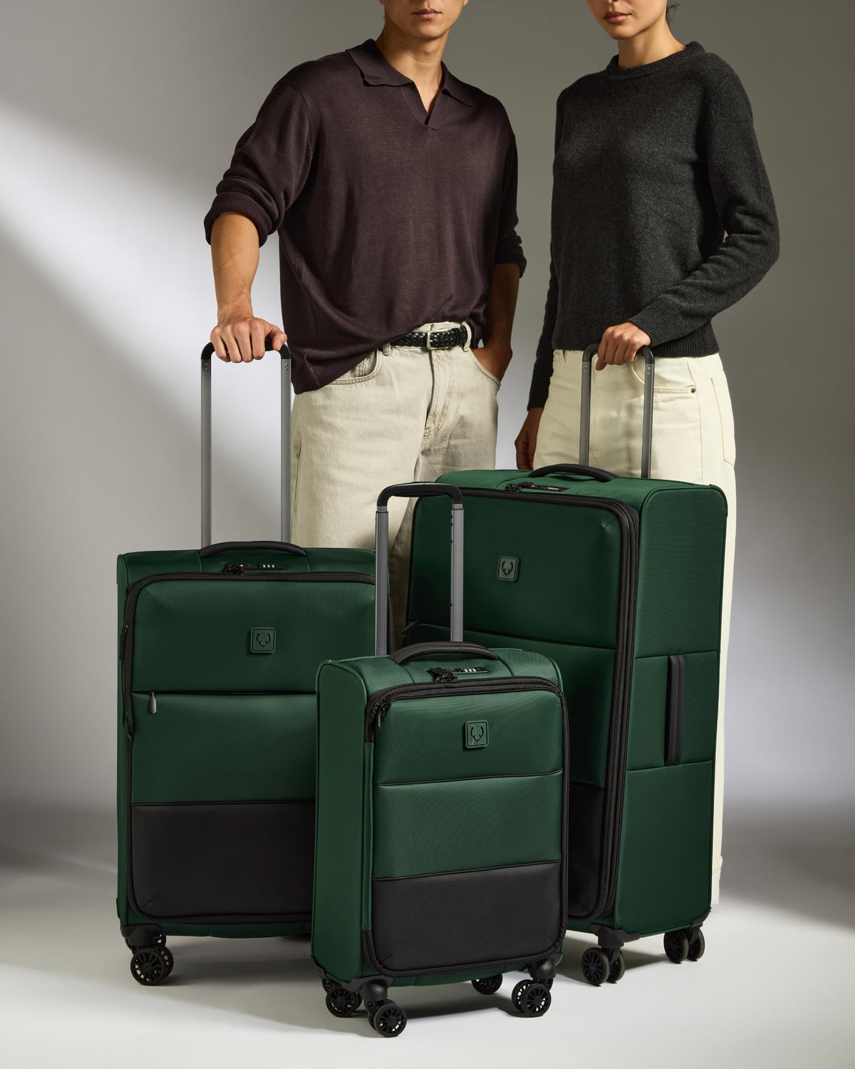 a man and woman standing next to a group of luggage