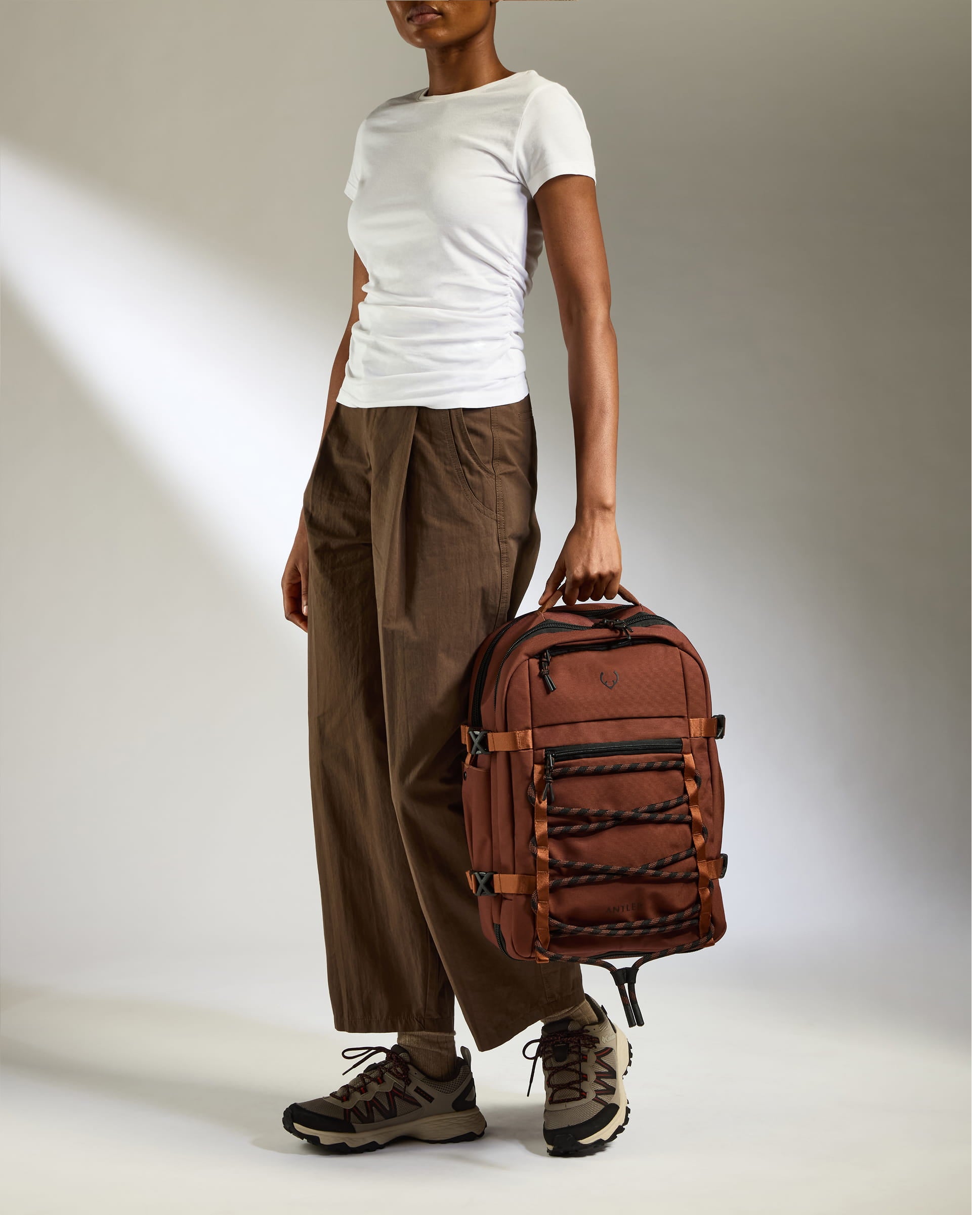 a woman holding a backpack