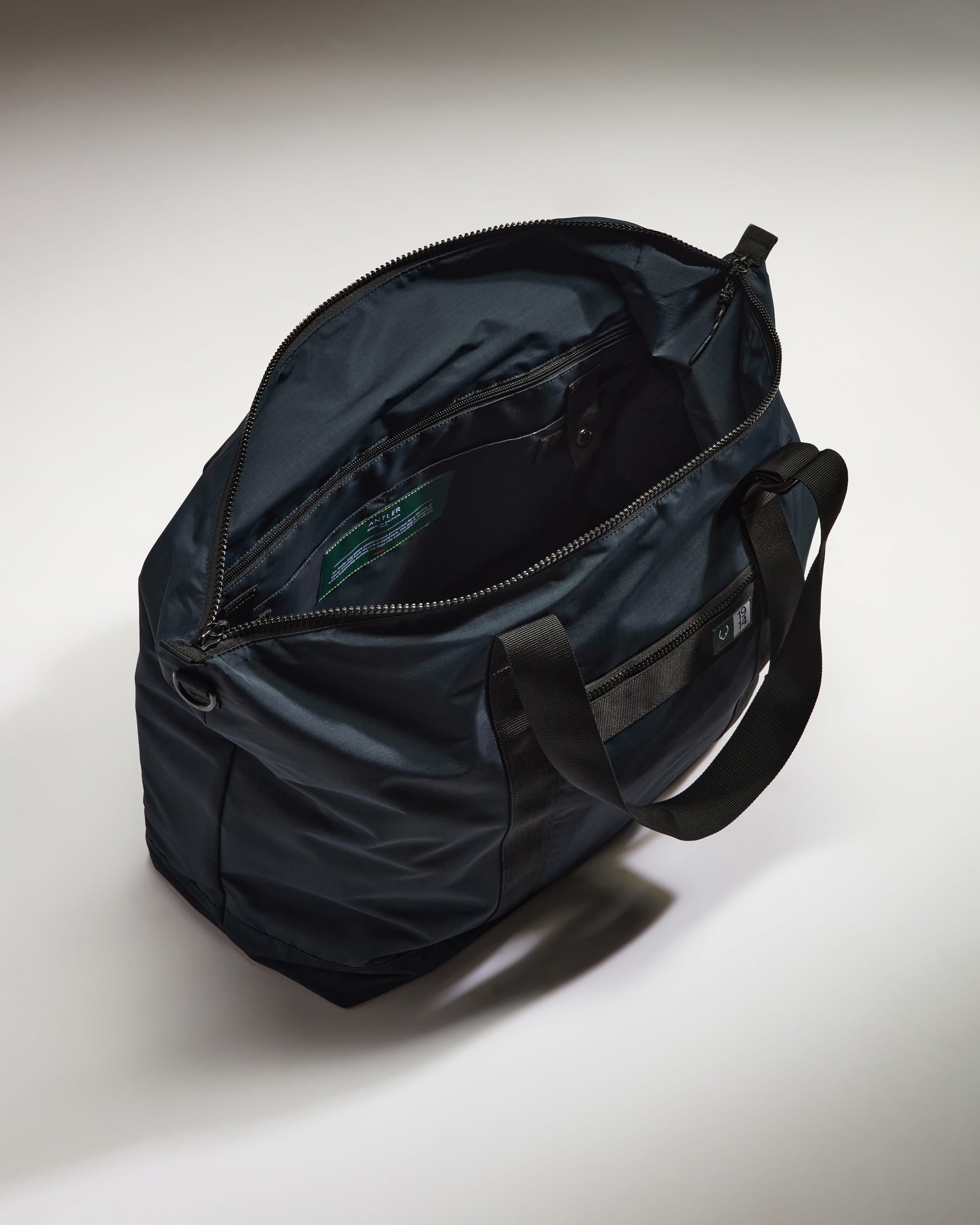a black bag with a green label inside