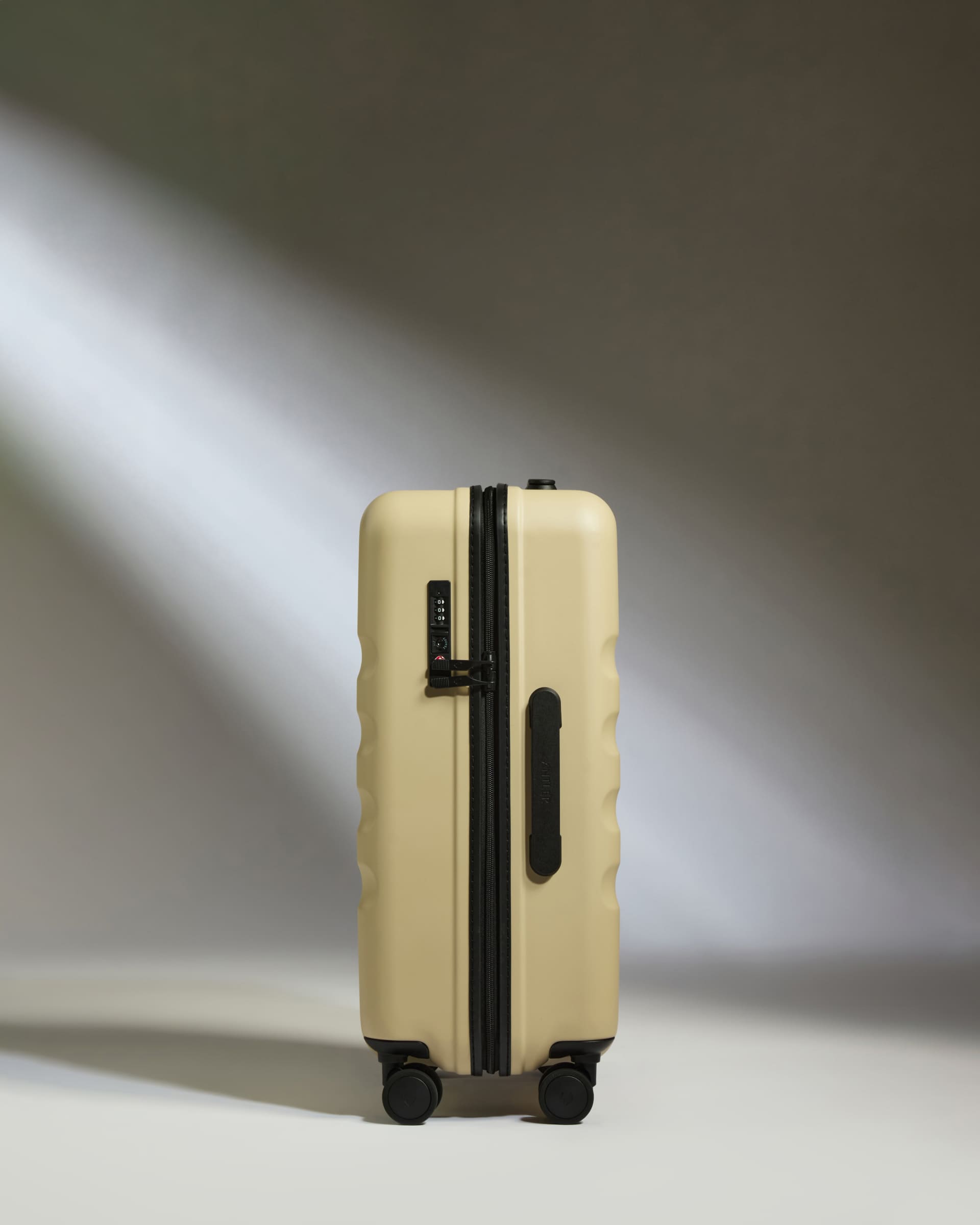 a tan suitcase with wheels