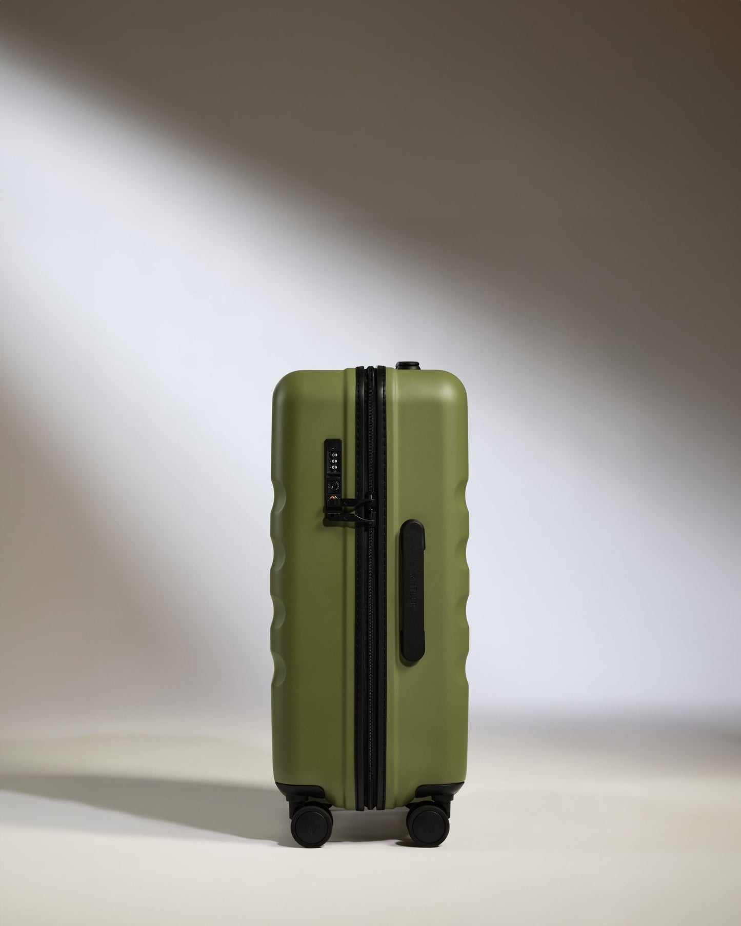 a green suitcase with wheels