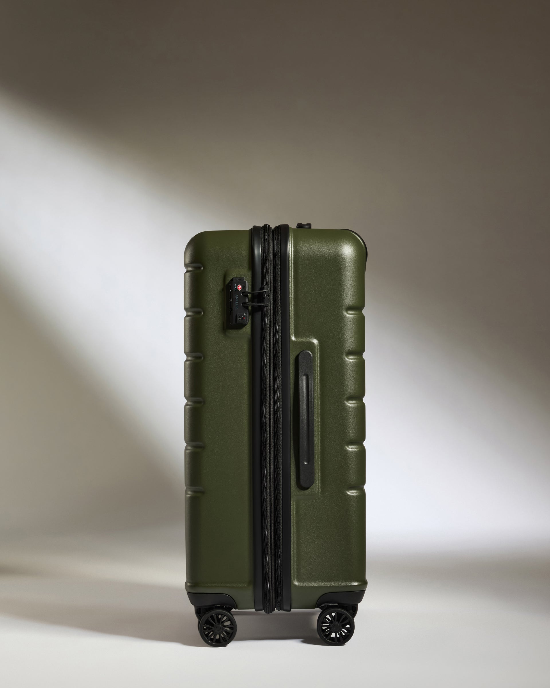 a green suitcase with wheels