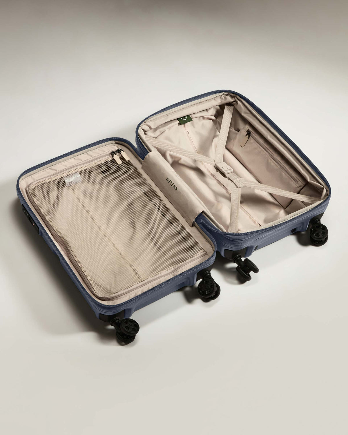 a suitcase with wheels and a mesh inside