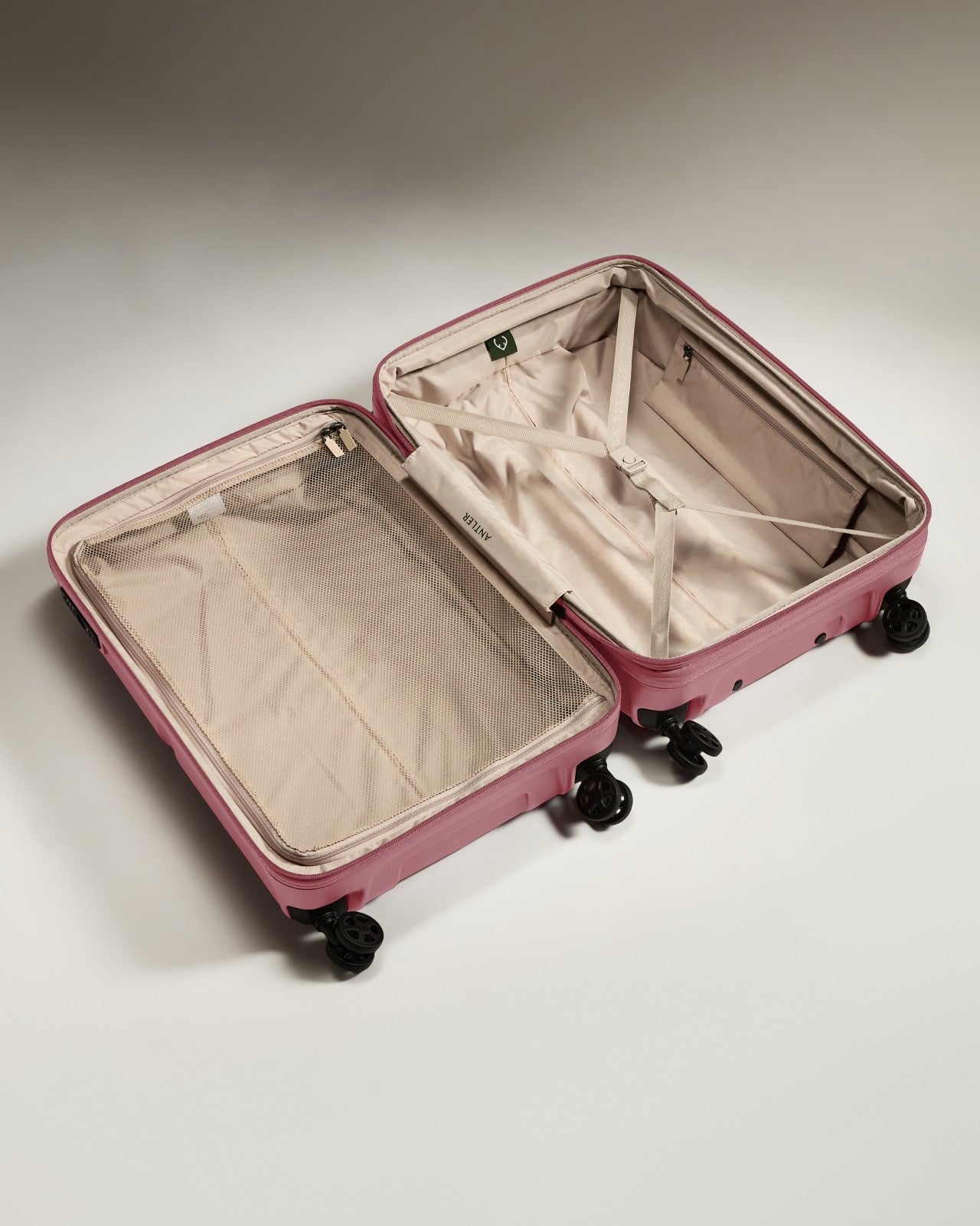a pink suitcase with wheels