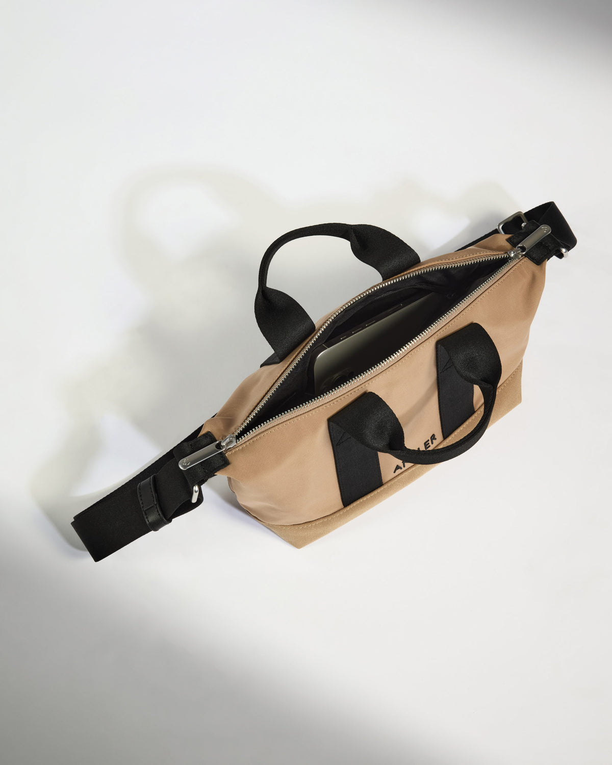 a tan bag with black straps