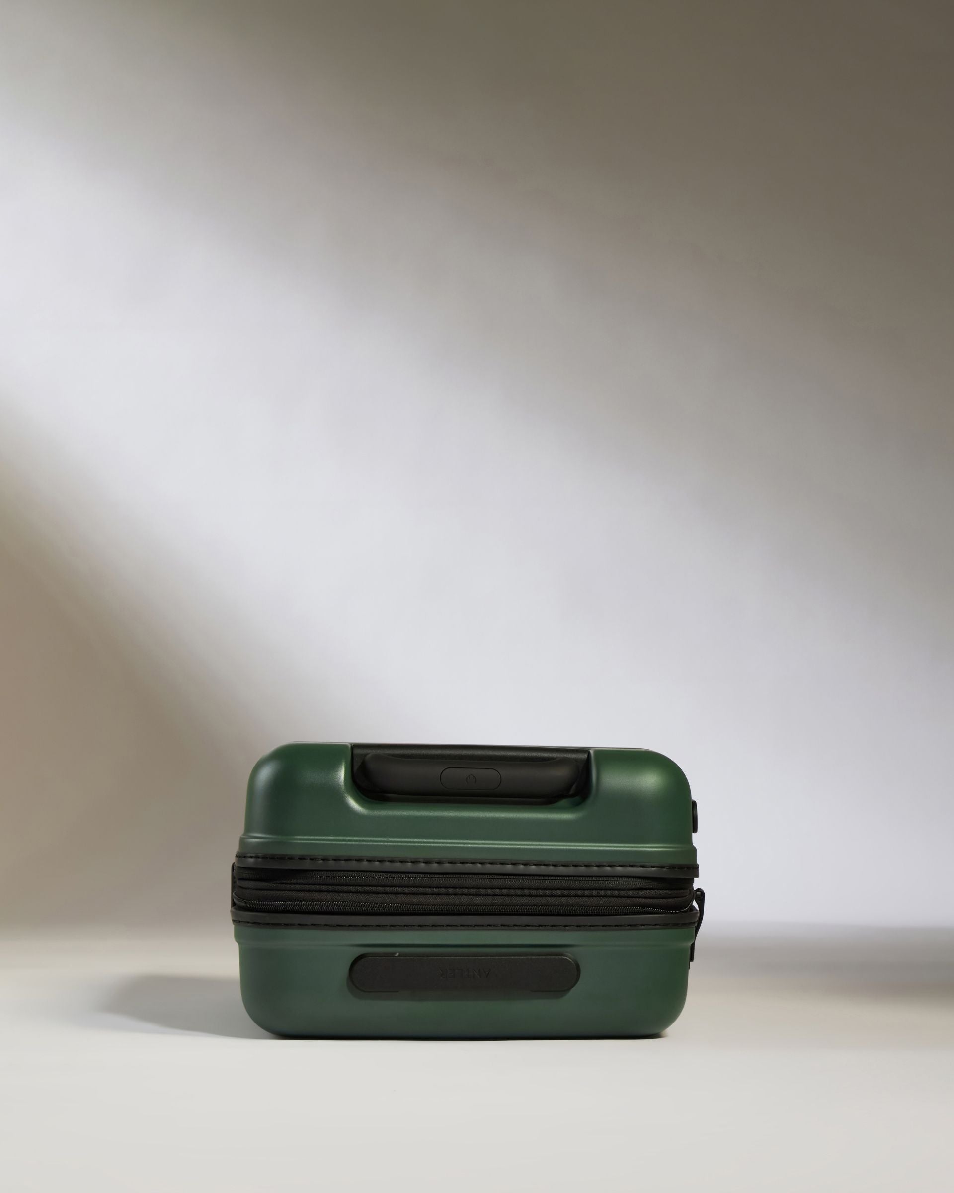 a green suitcase with a zipper