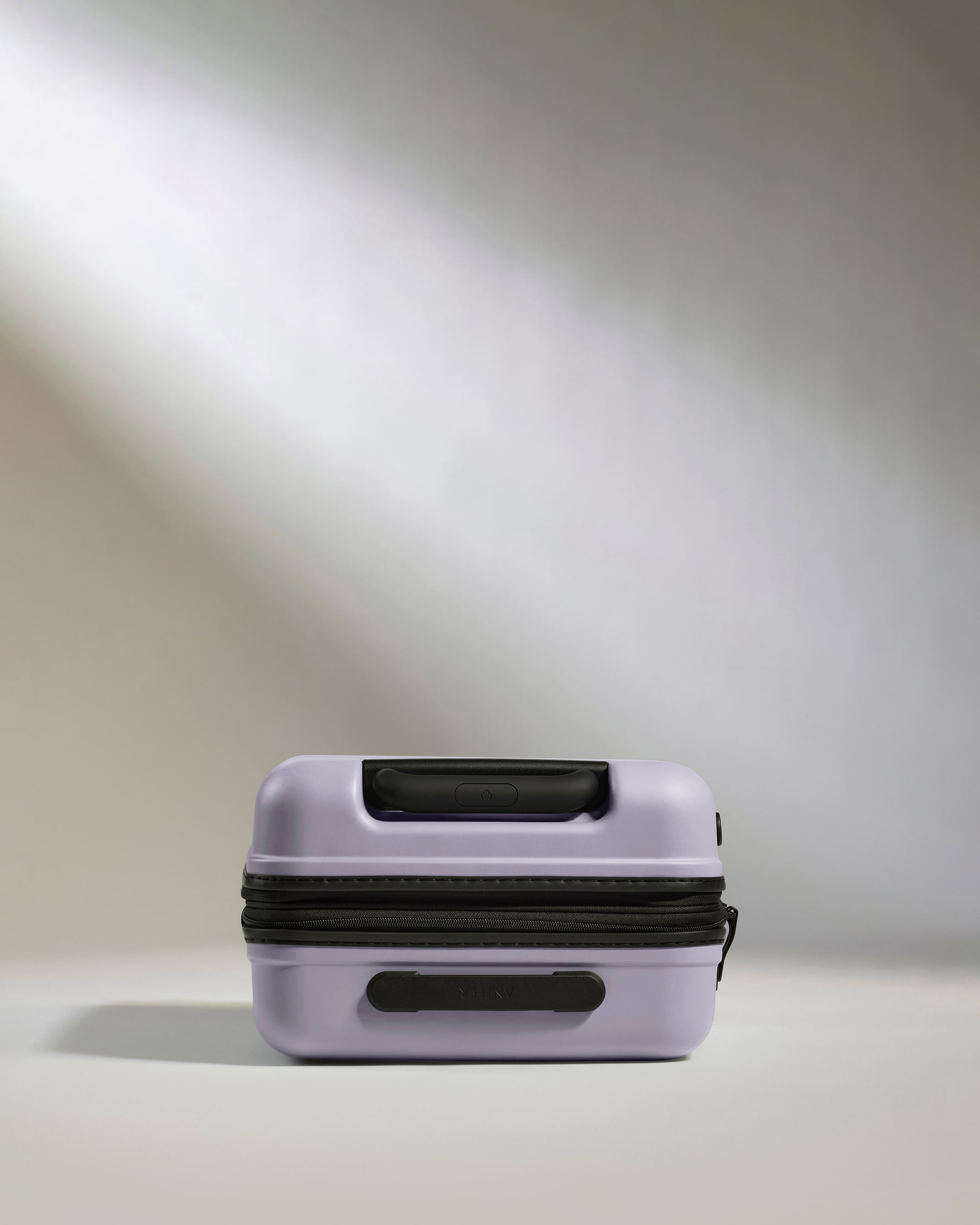 a purple suitcase with a black handle