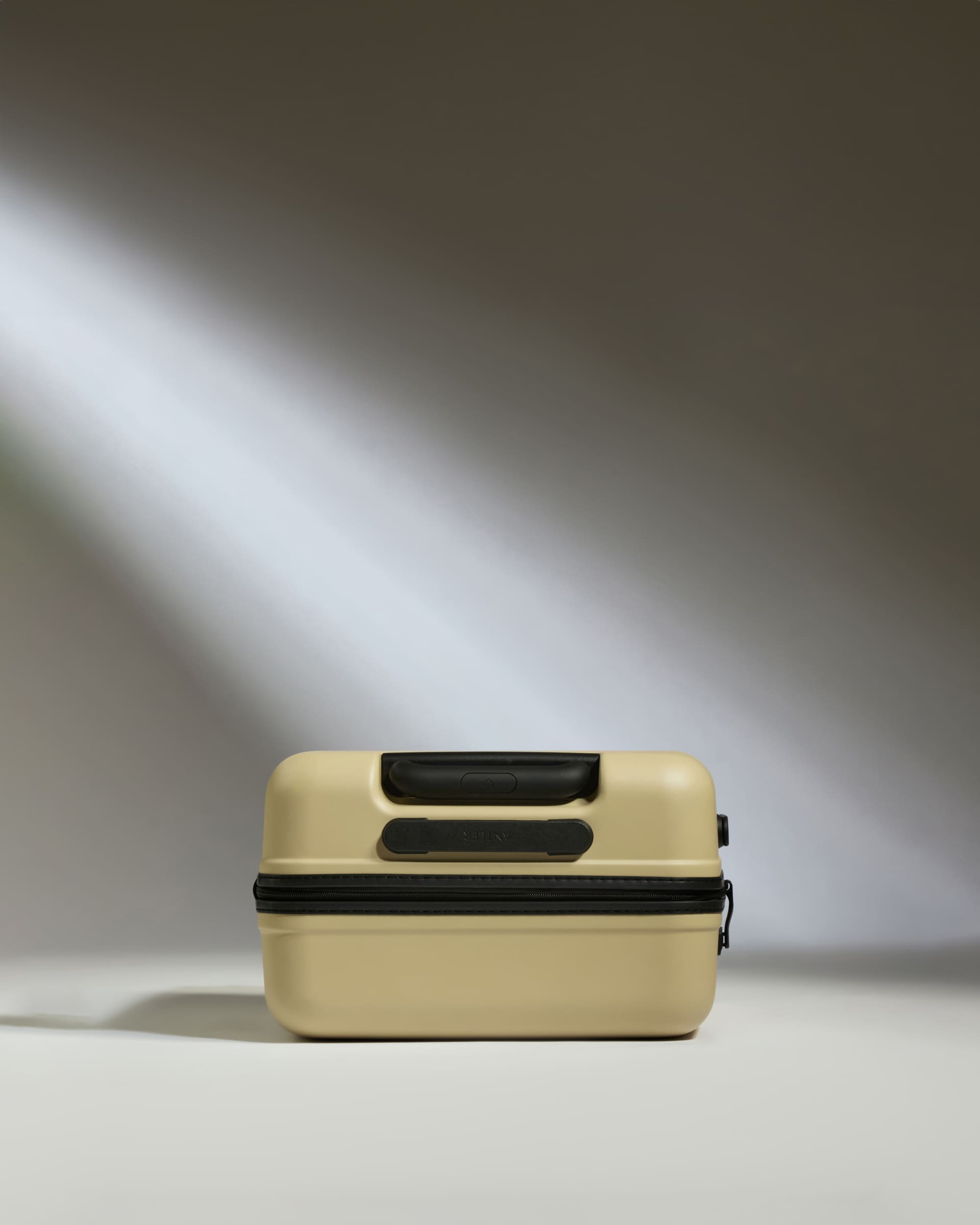 a tan and black suitcase