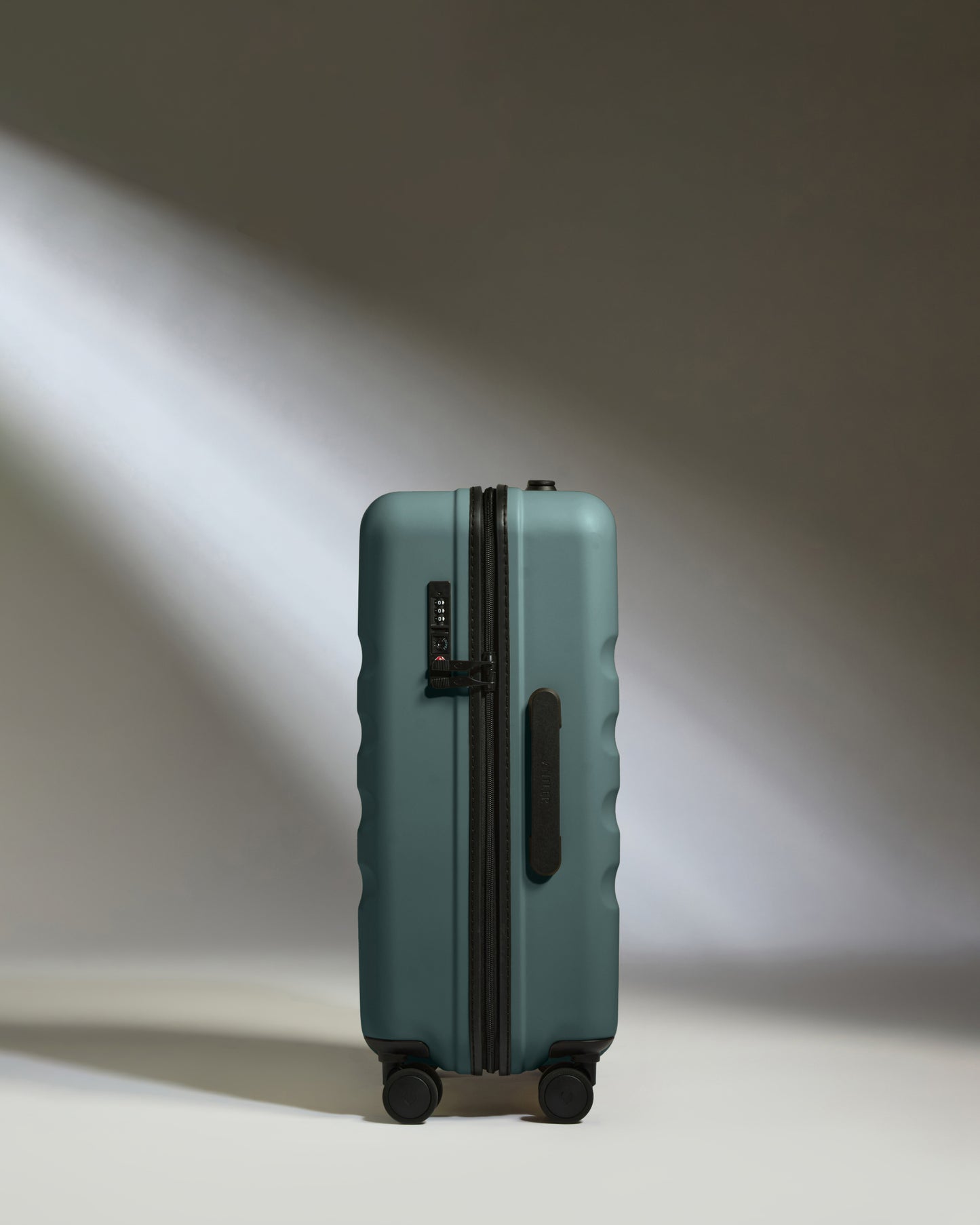 a suitcase with wheels and light shining on it