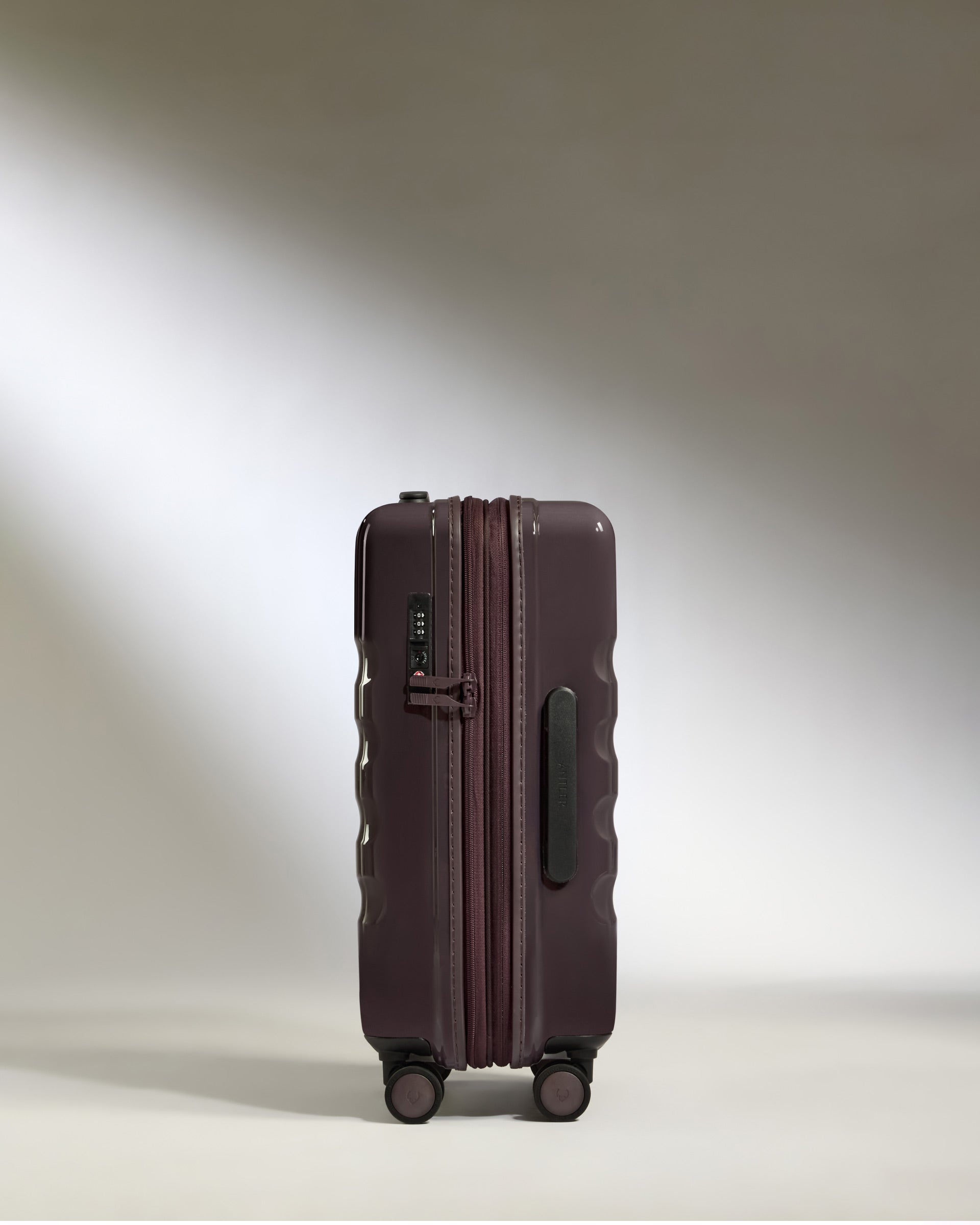 a purple suitcase with wheels