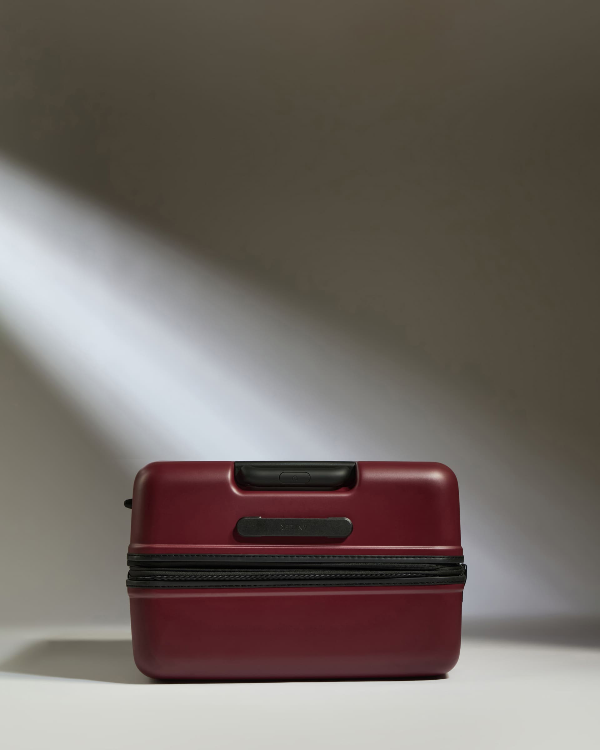 a red suitcase with a light shining on it