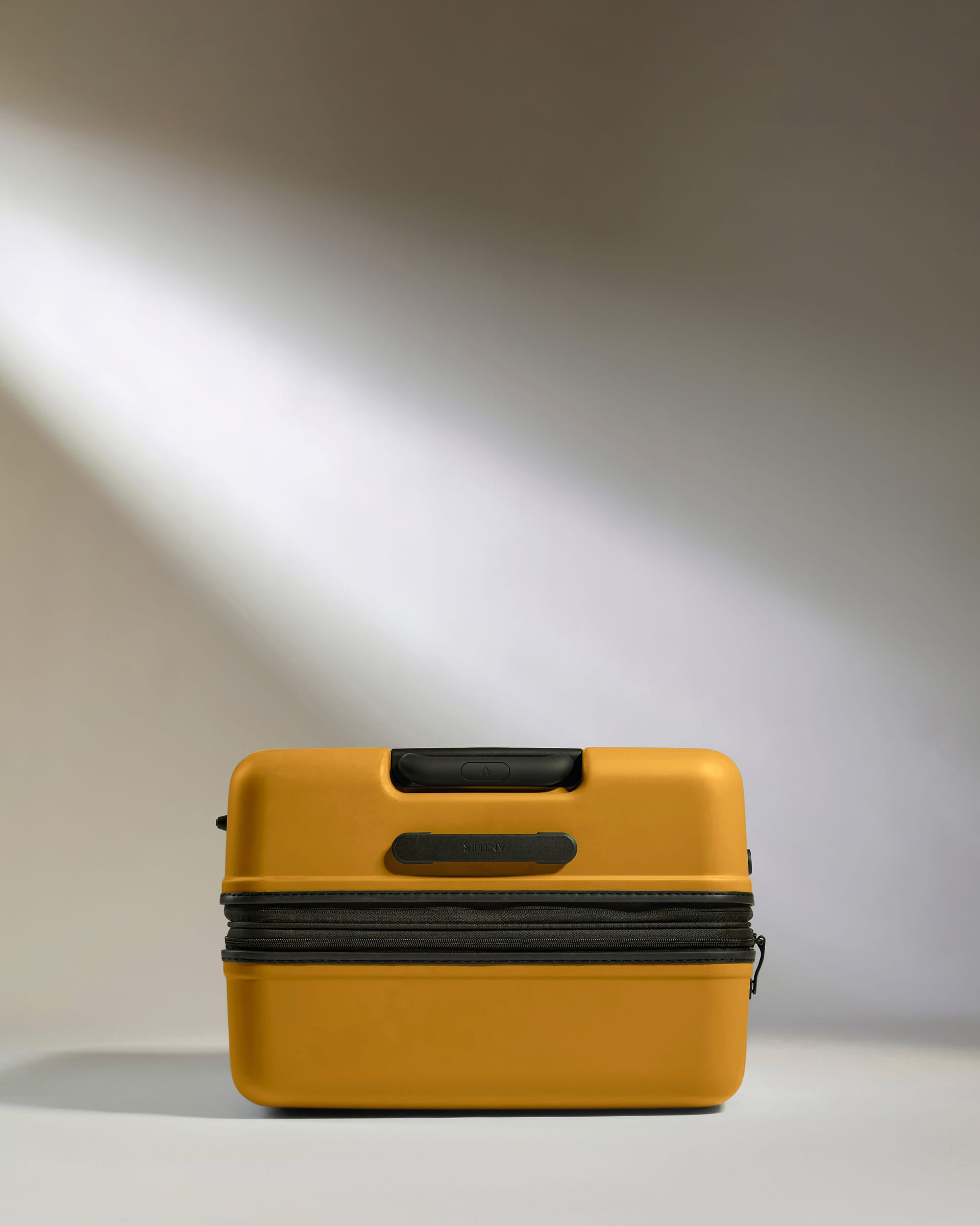 a yellow suitcase with a light shining on it