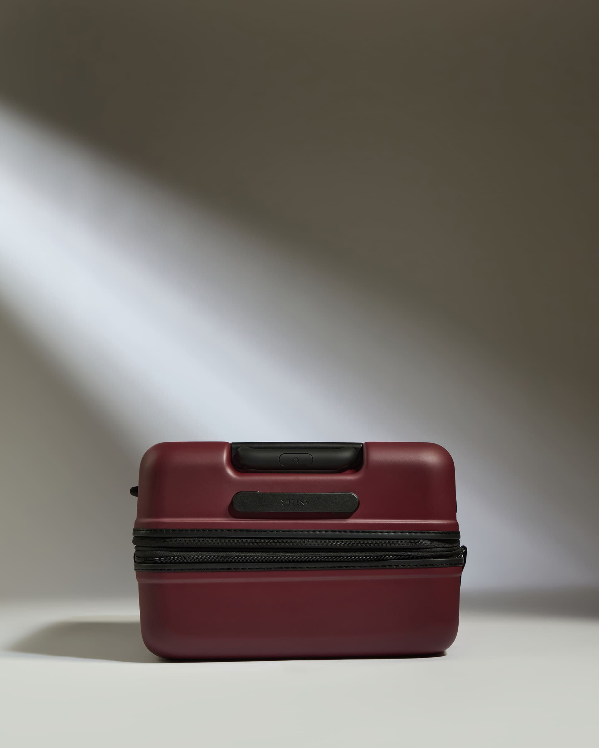 a red suitcase with a light shining on it