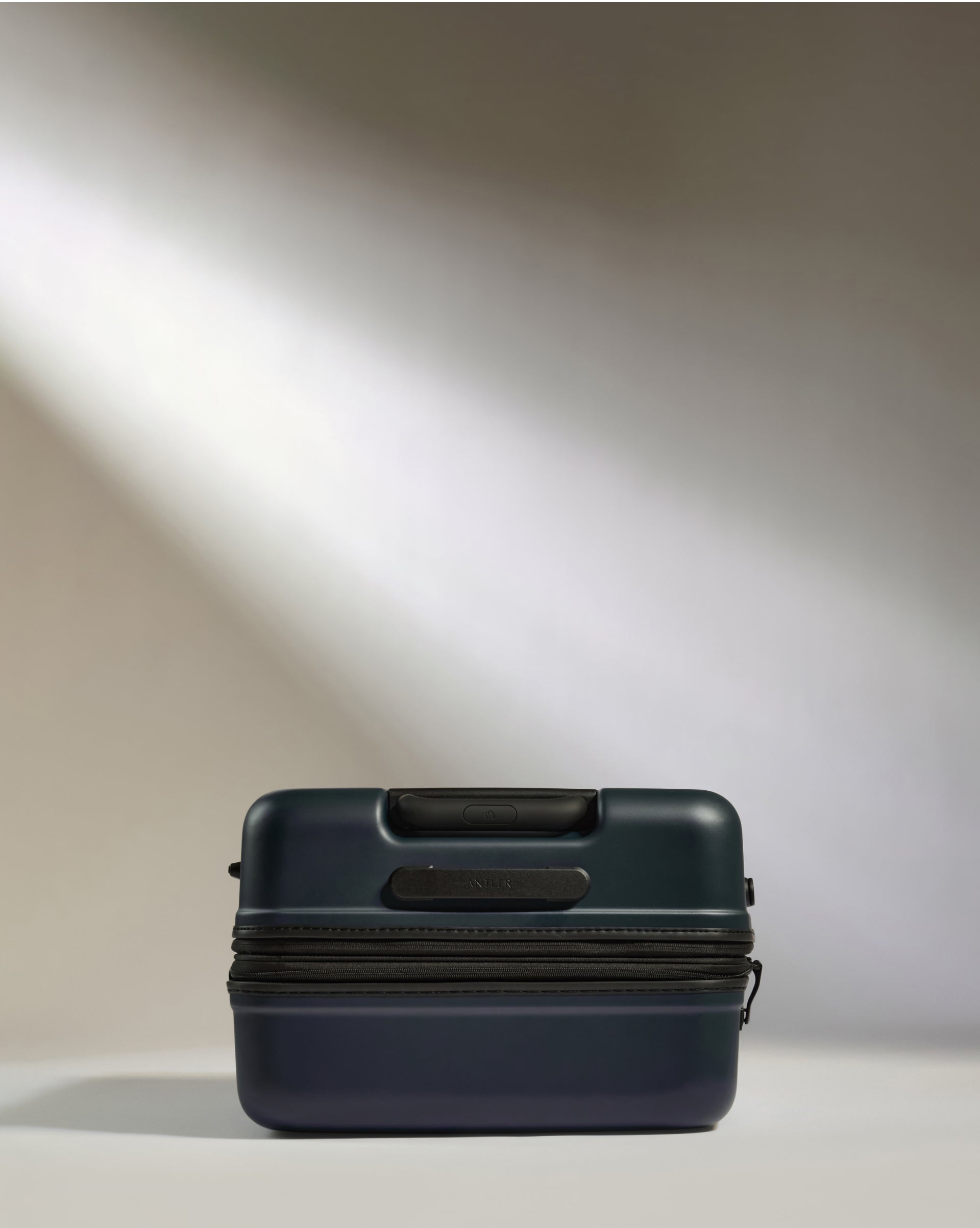 a blue suitcase with a light shining on it