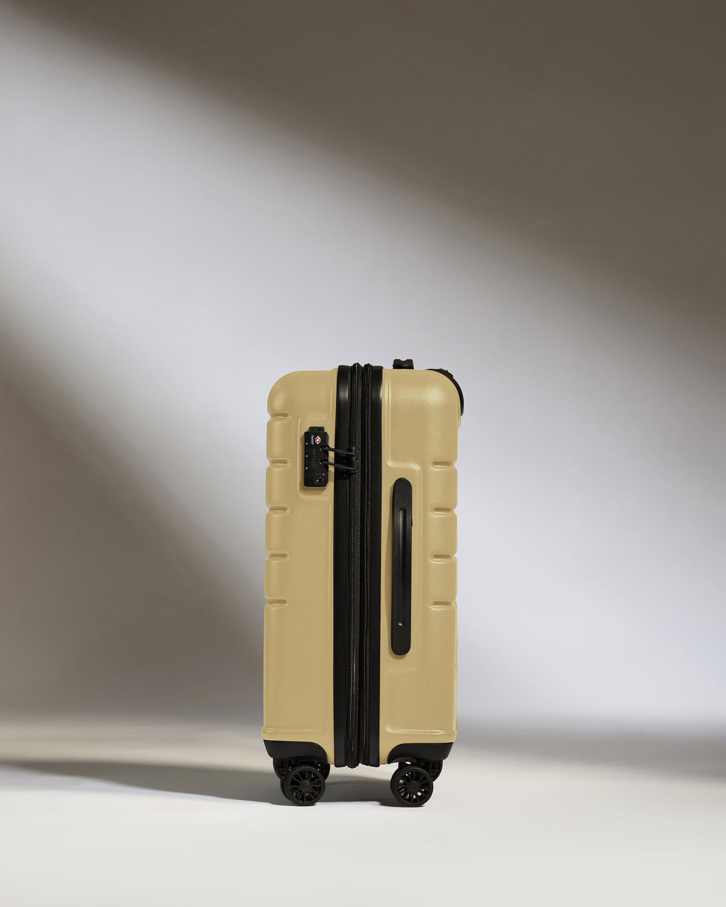 a tan suitcase with wheels