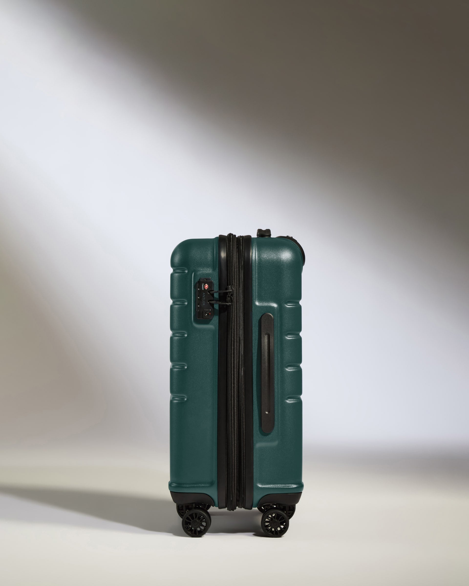 a green suitcase with wheels