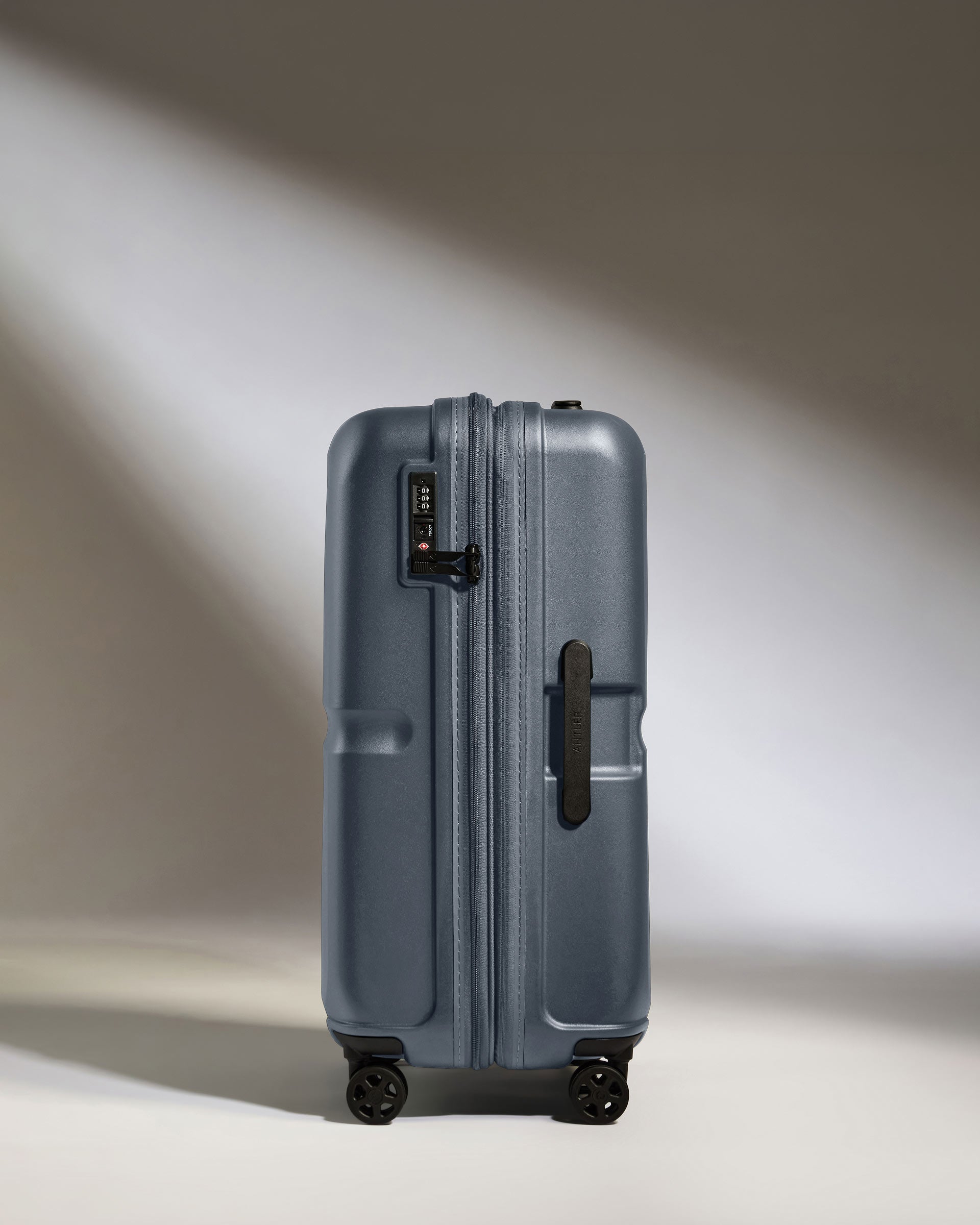 a suitcase with wheels and a light shining on it