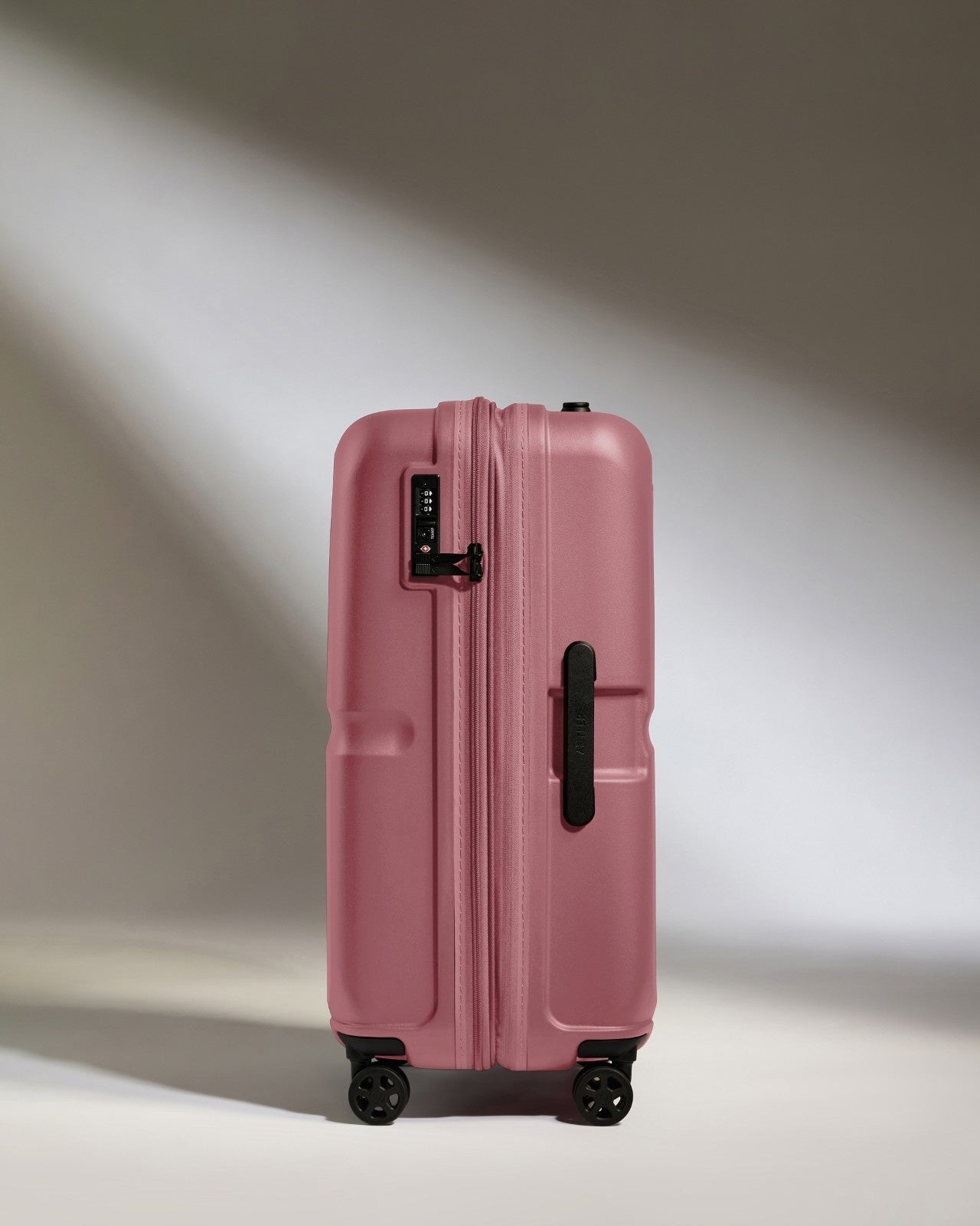 a pink suitcase with wheels