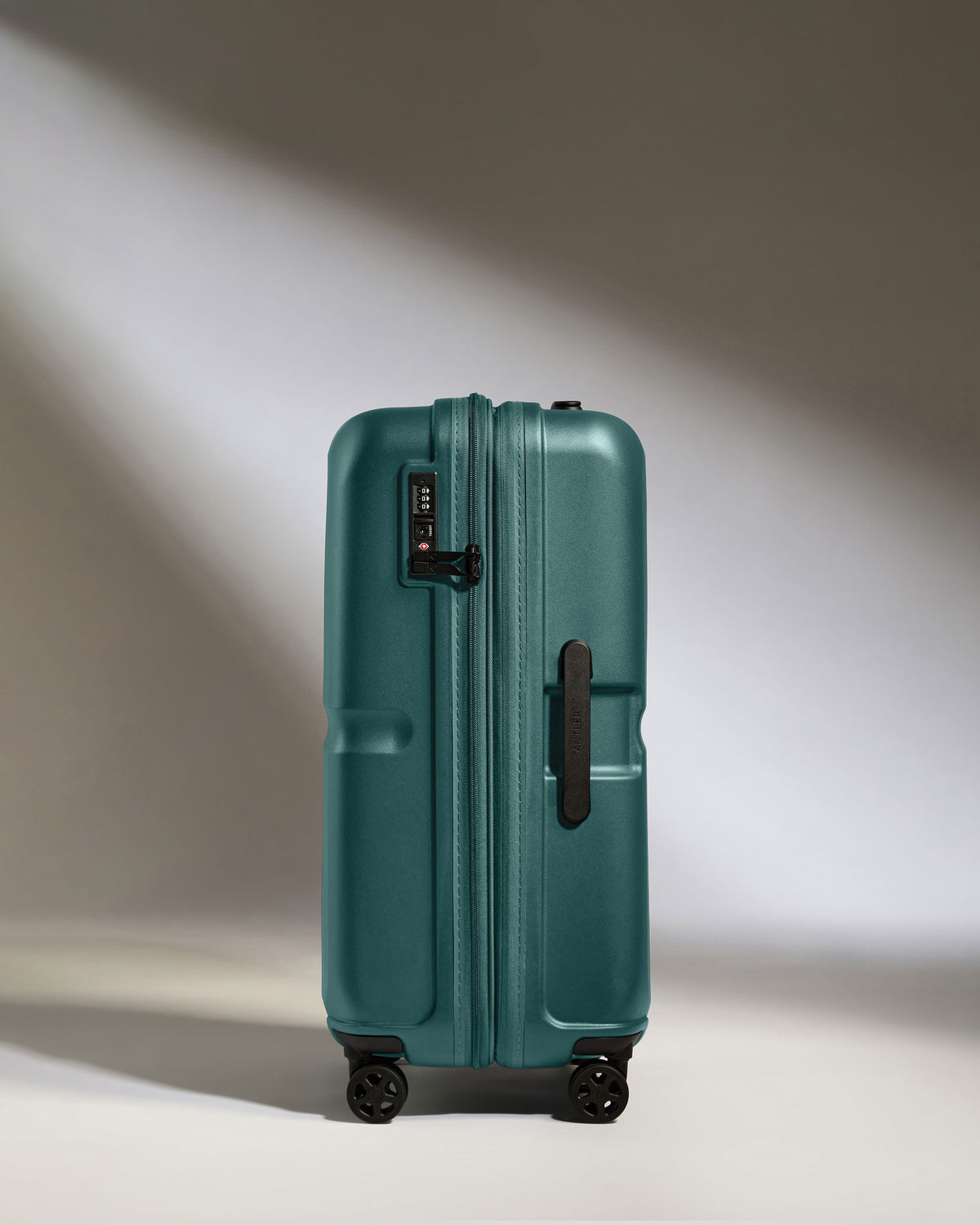 a suitcase on wheels with light shining on it