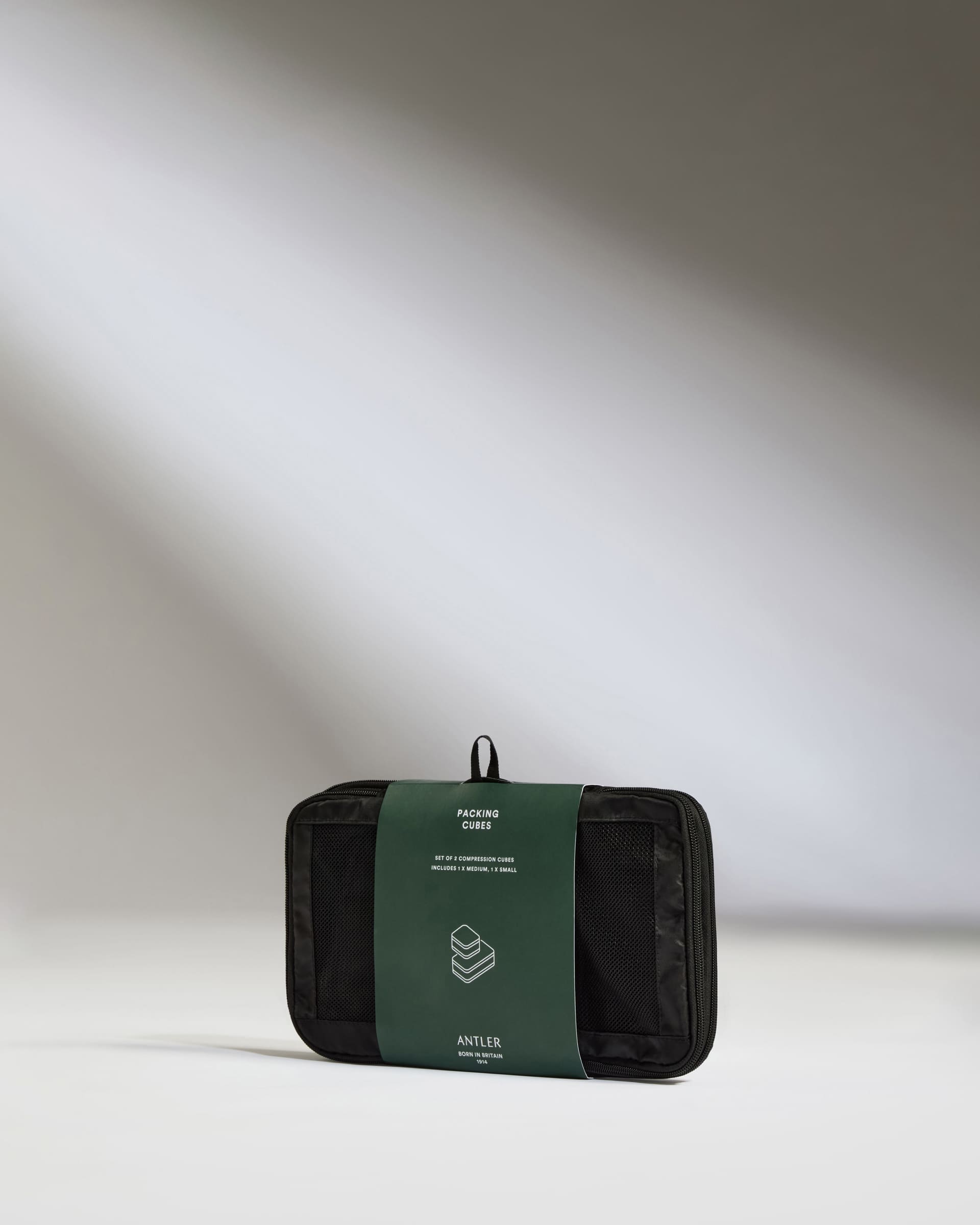 a black and green bag with a green label
