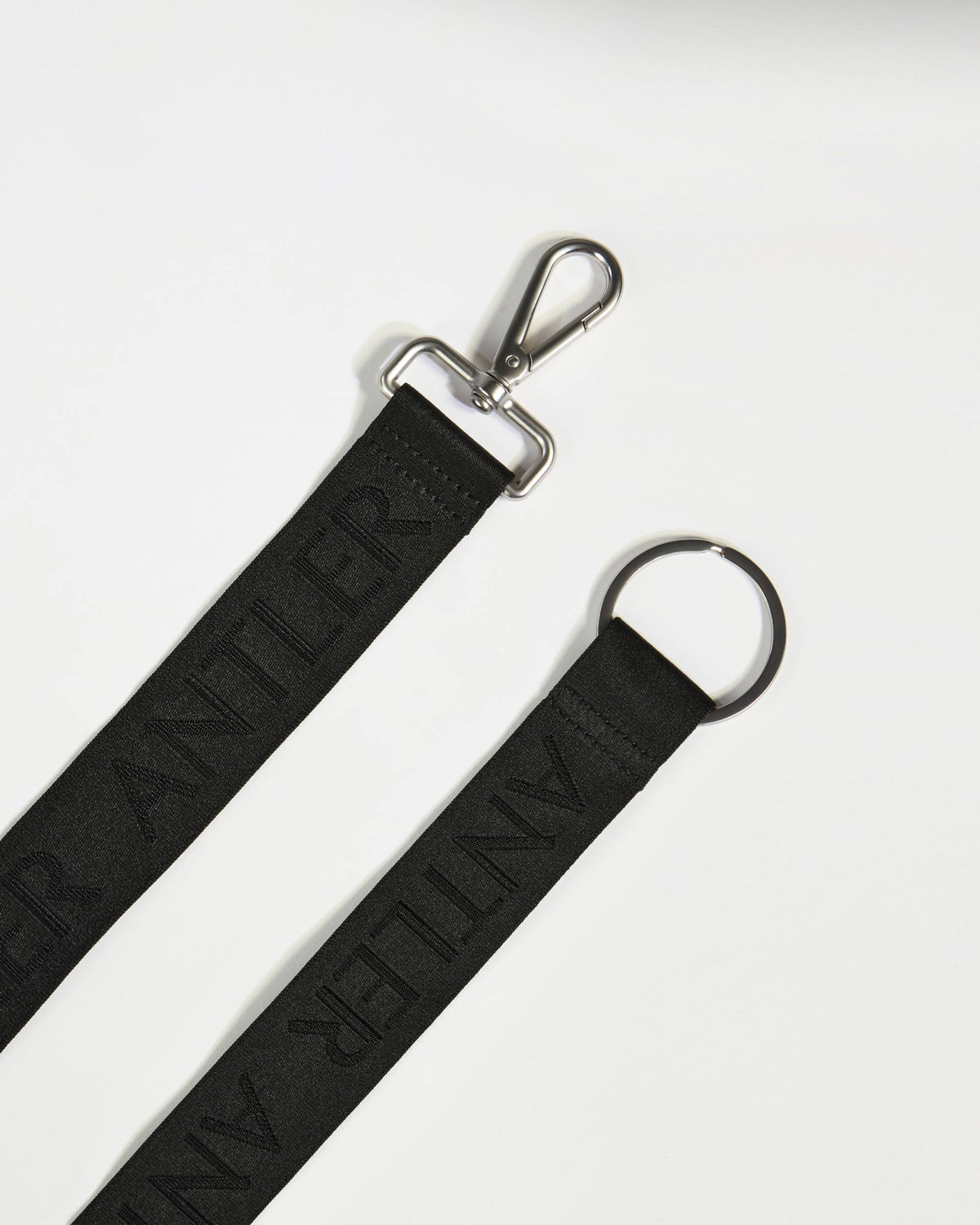 a black strap with a metal clasp