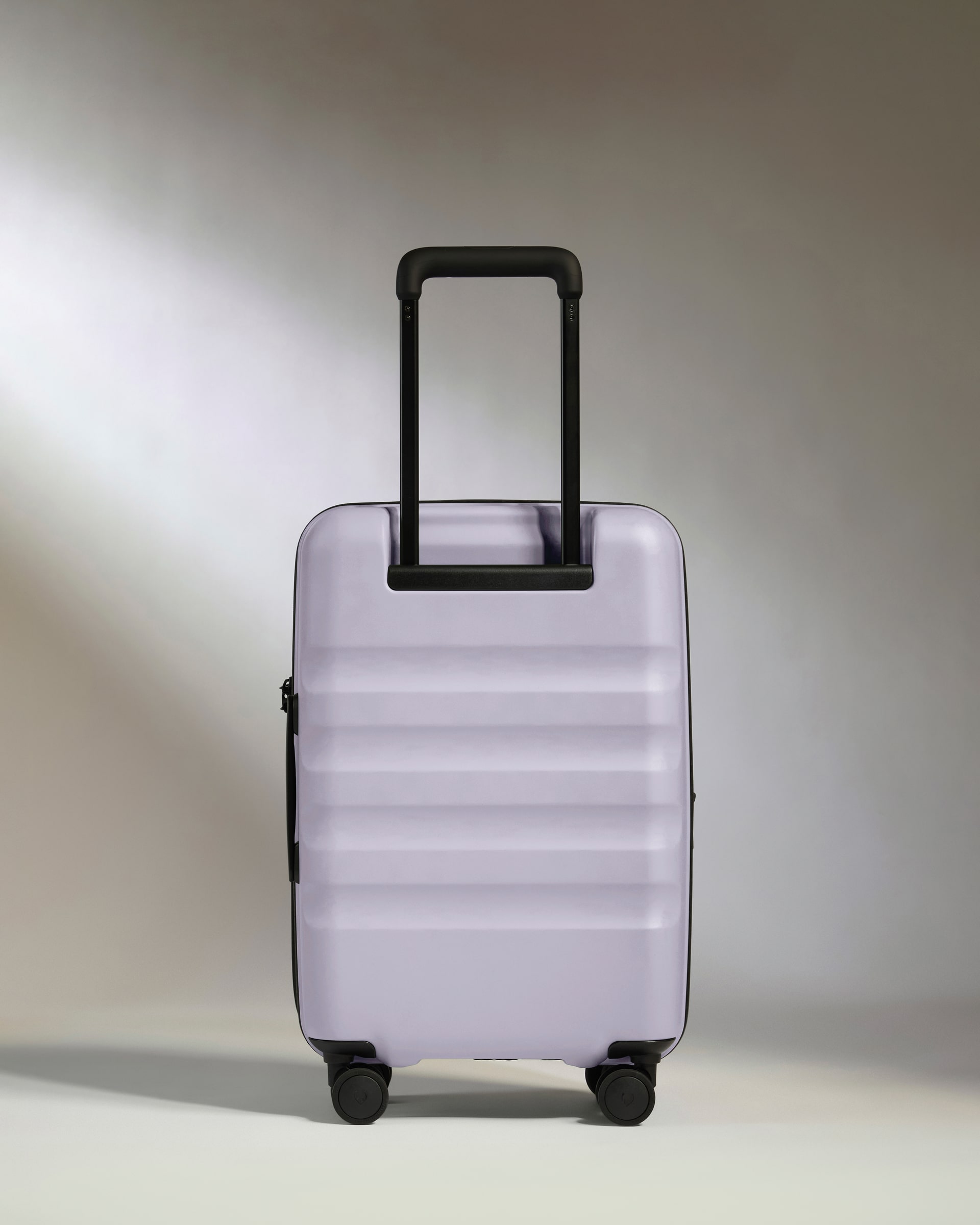 a purple suitcase with black wheels