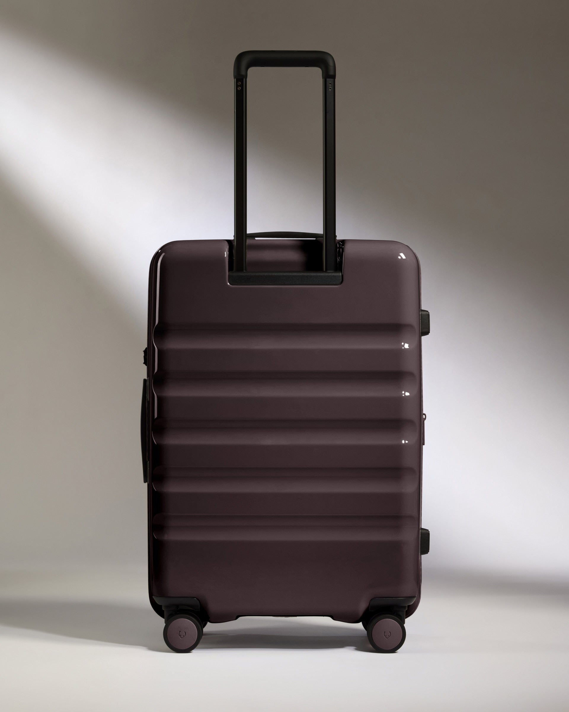 a purple suitcase with wheels