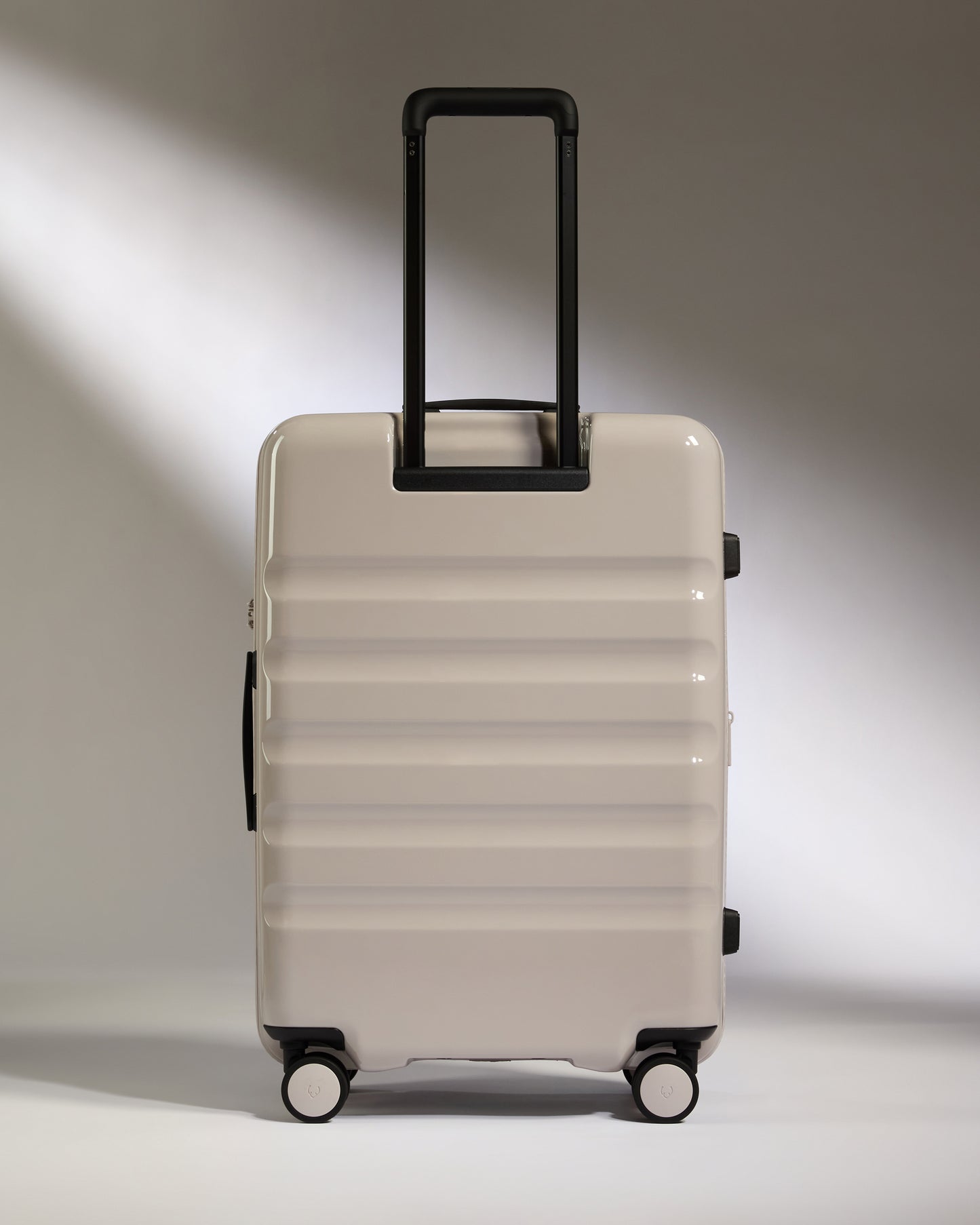 a white suitcase with black handles