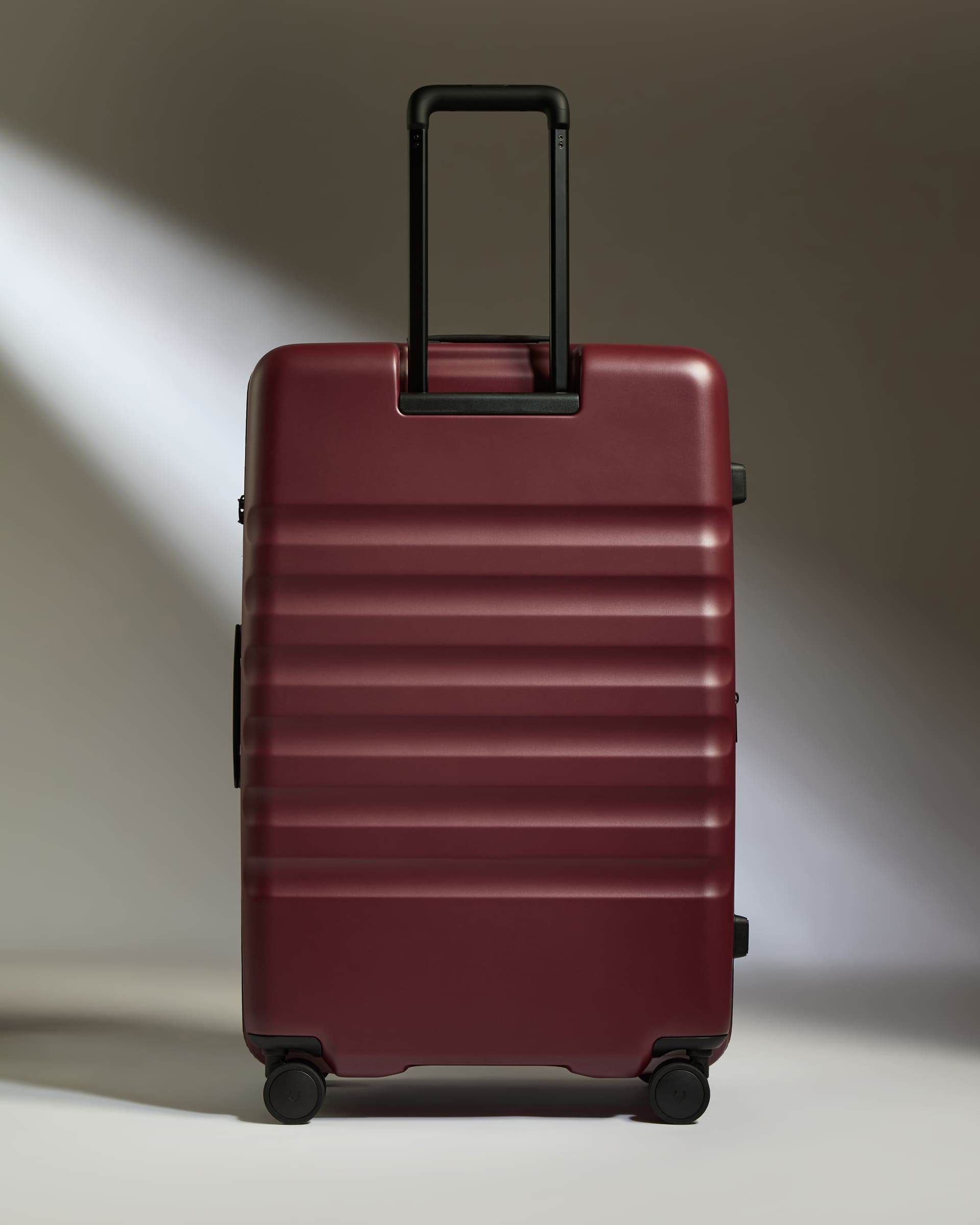a red suitcase with black handles