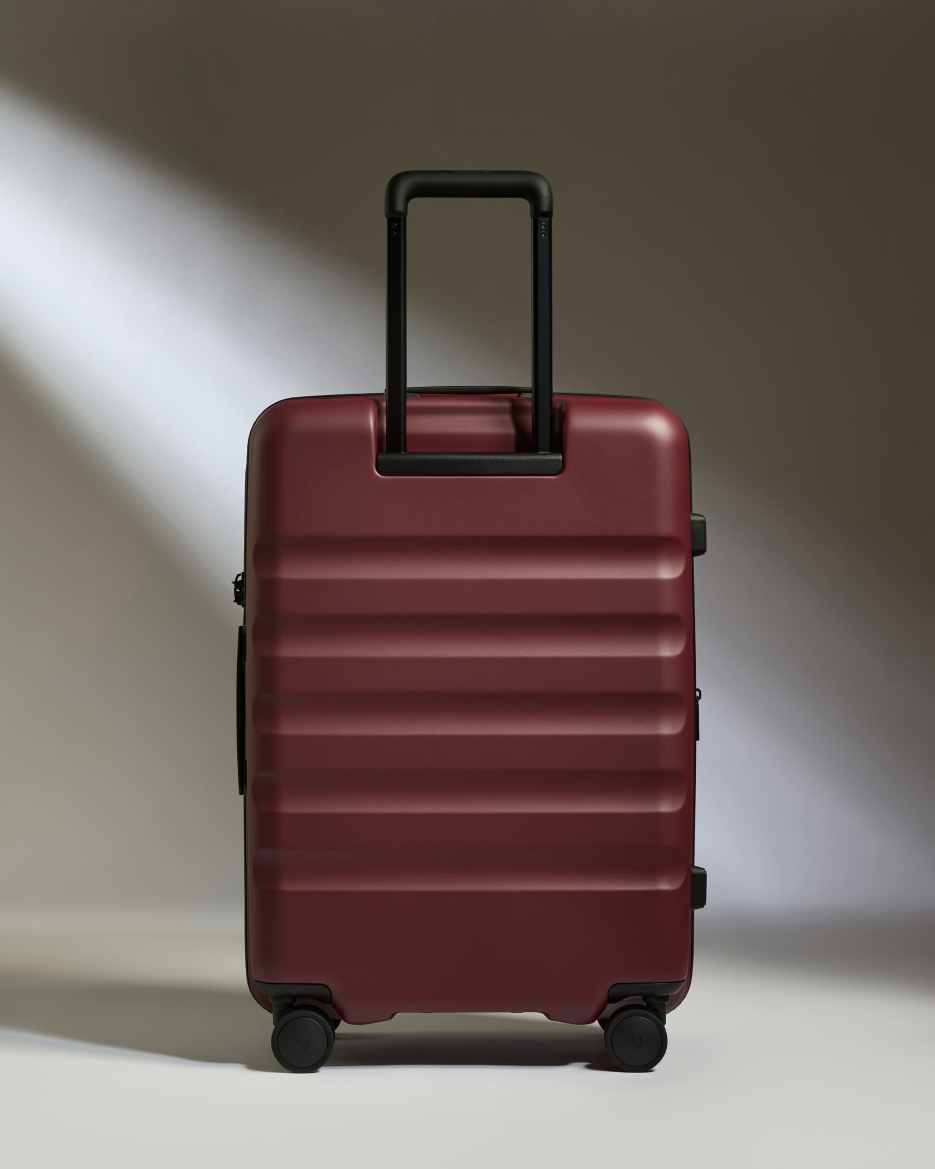 a red suitcase with a handle