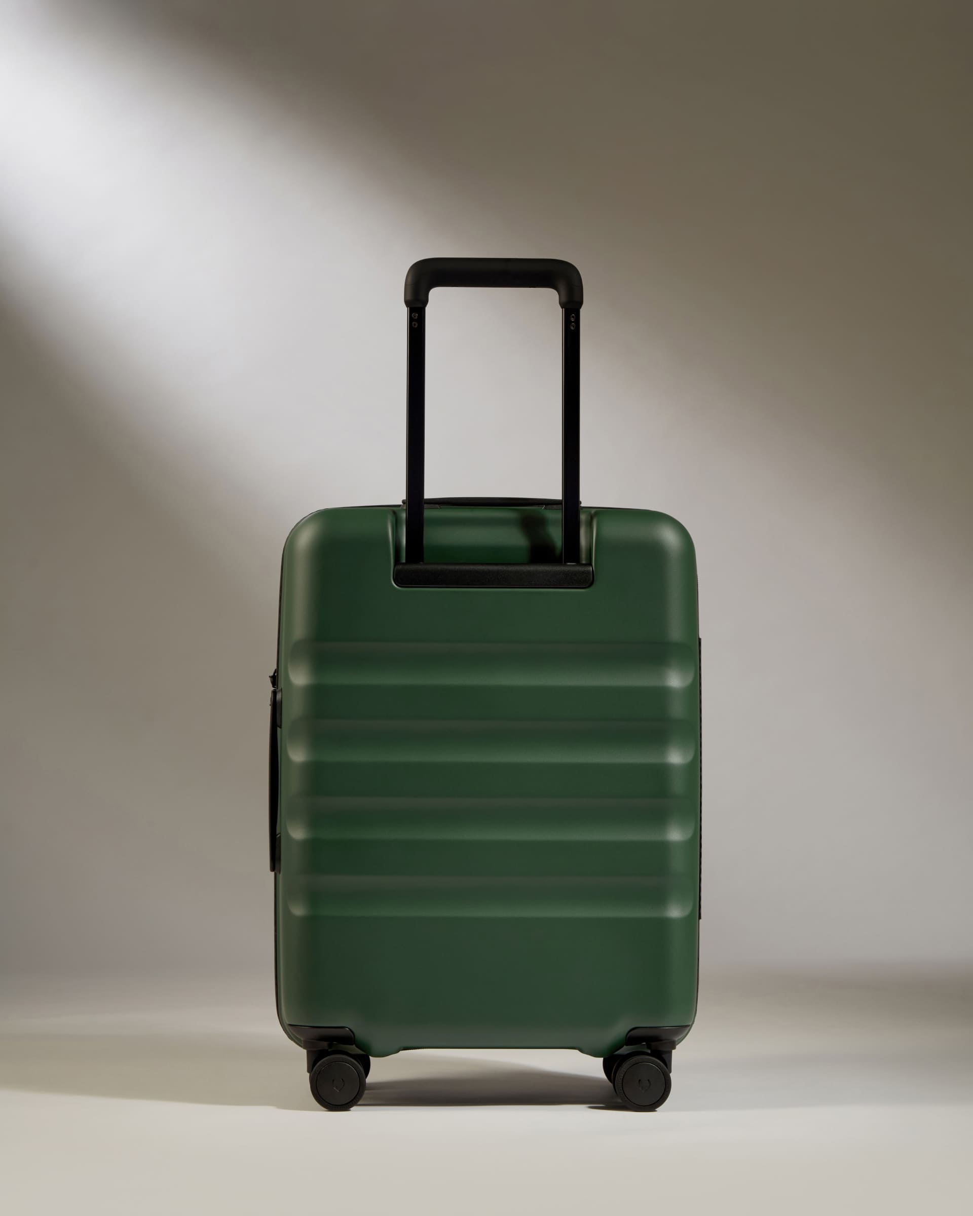 a green suitcase with a handle