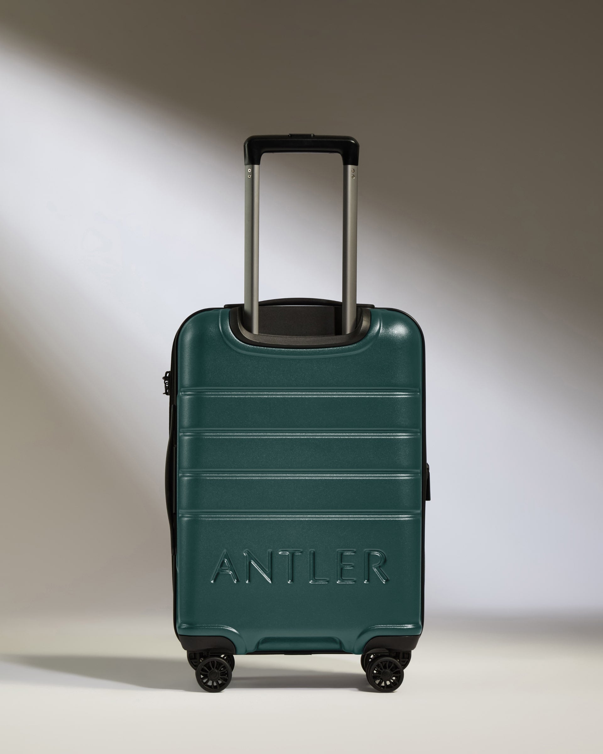 a green suitcase with handle