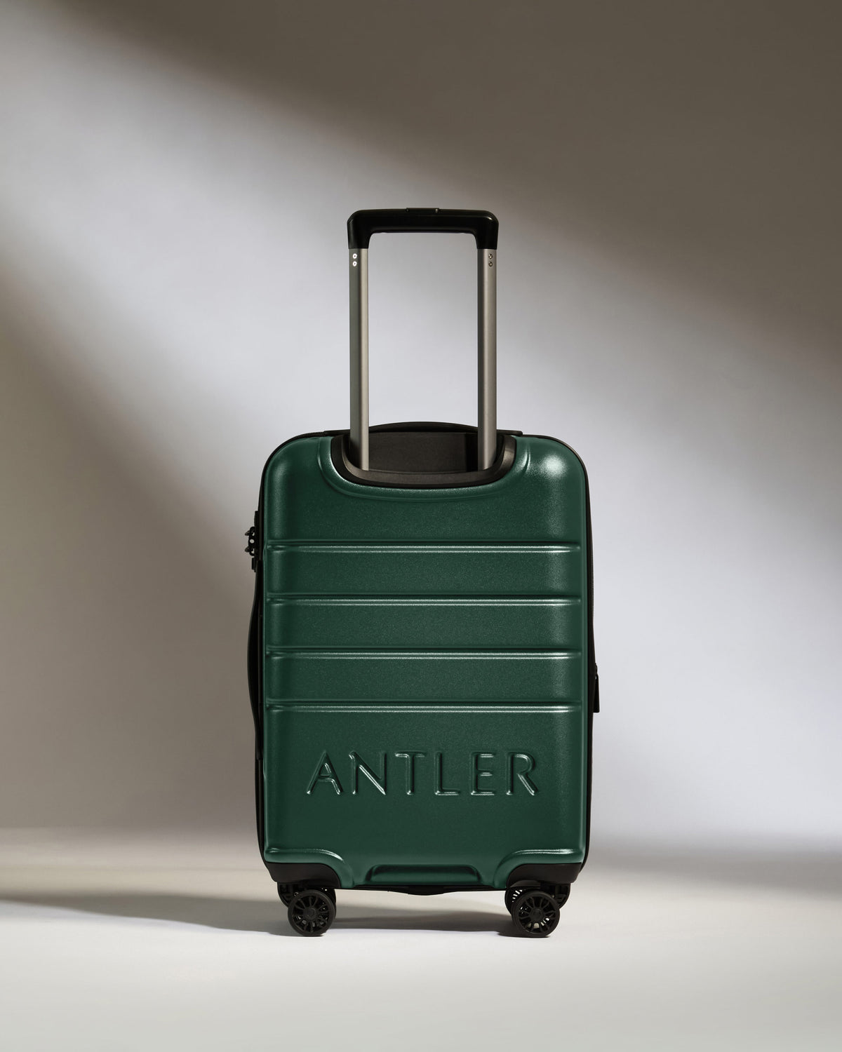 a green suitcase with handle