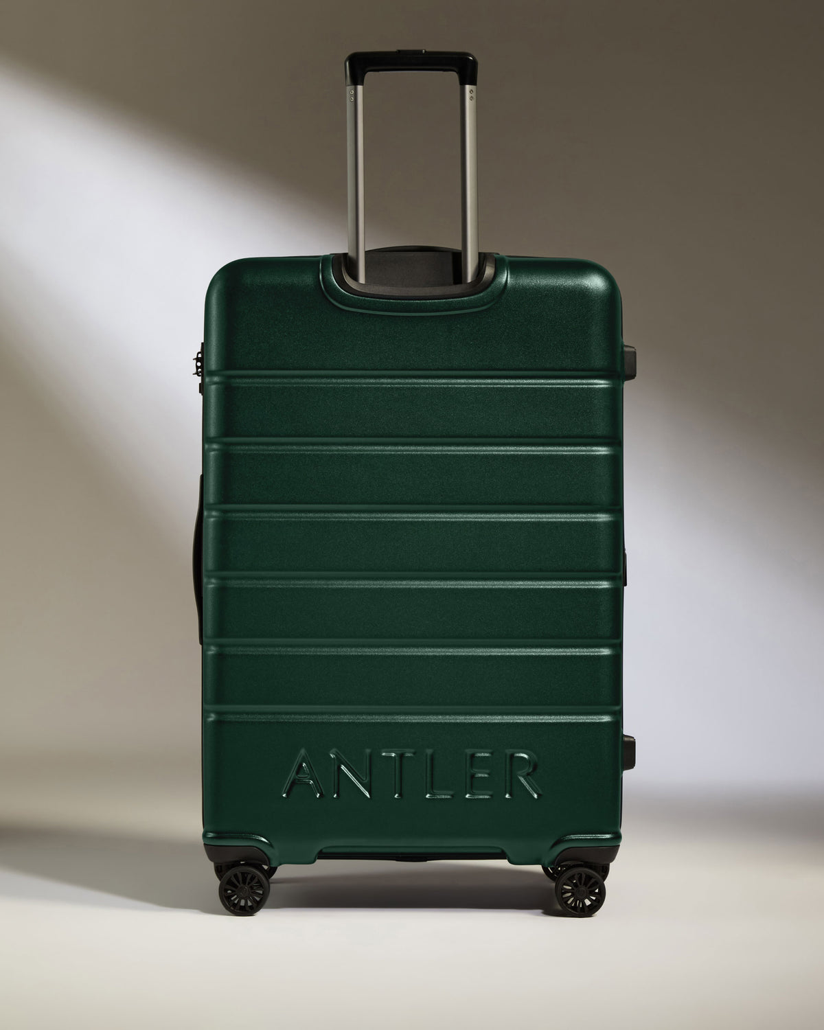 a green suitcase with handle