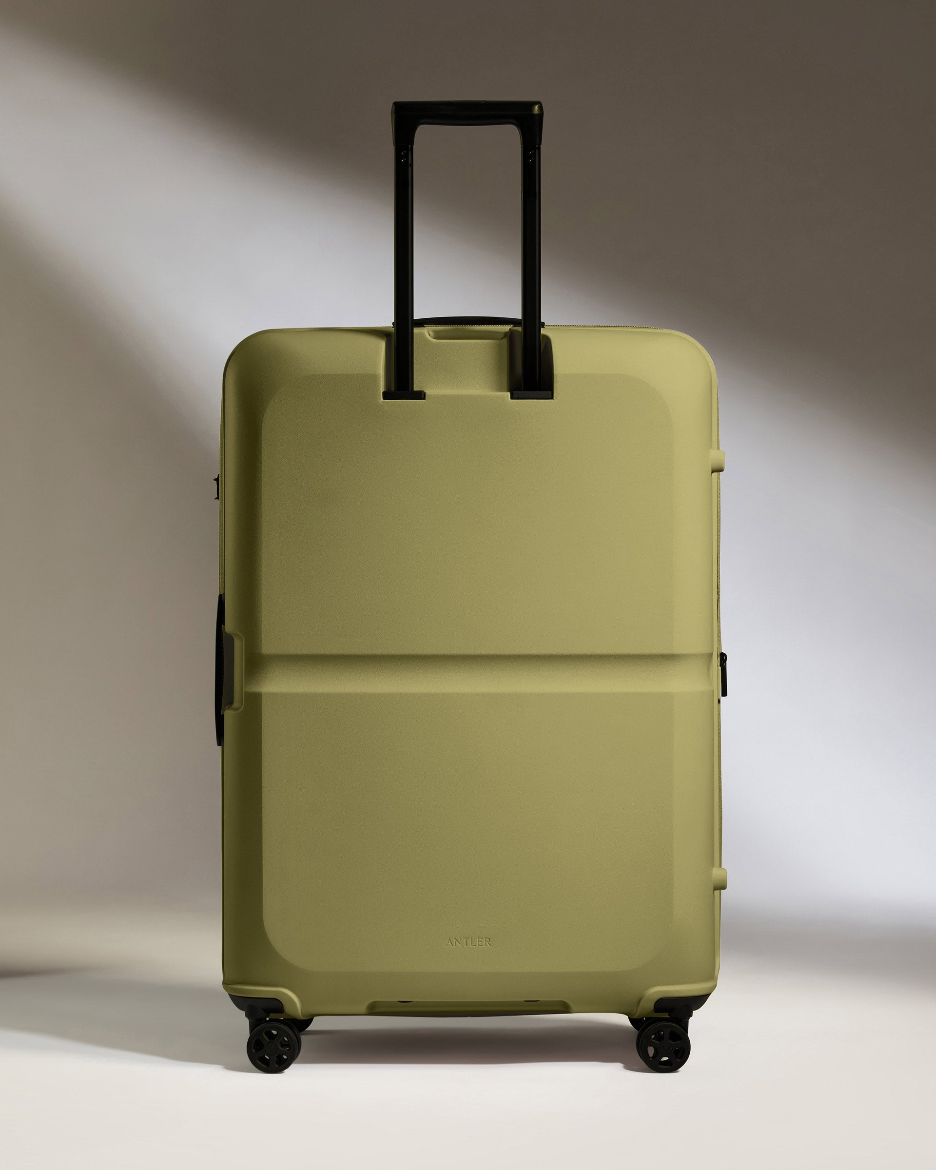 a green suitcase with black wheels