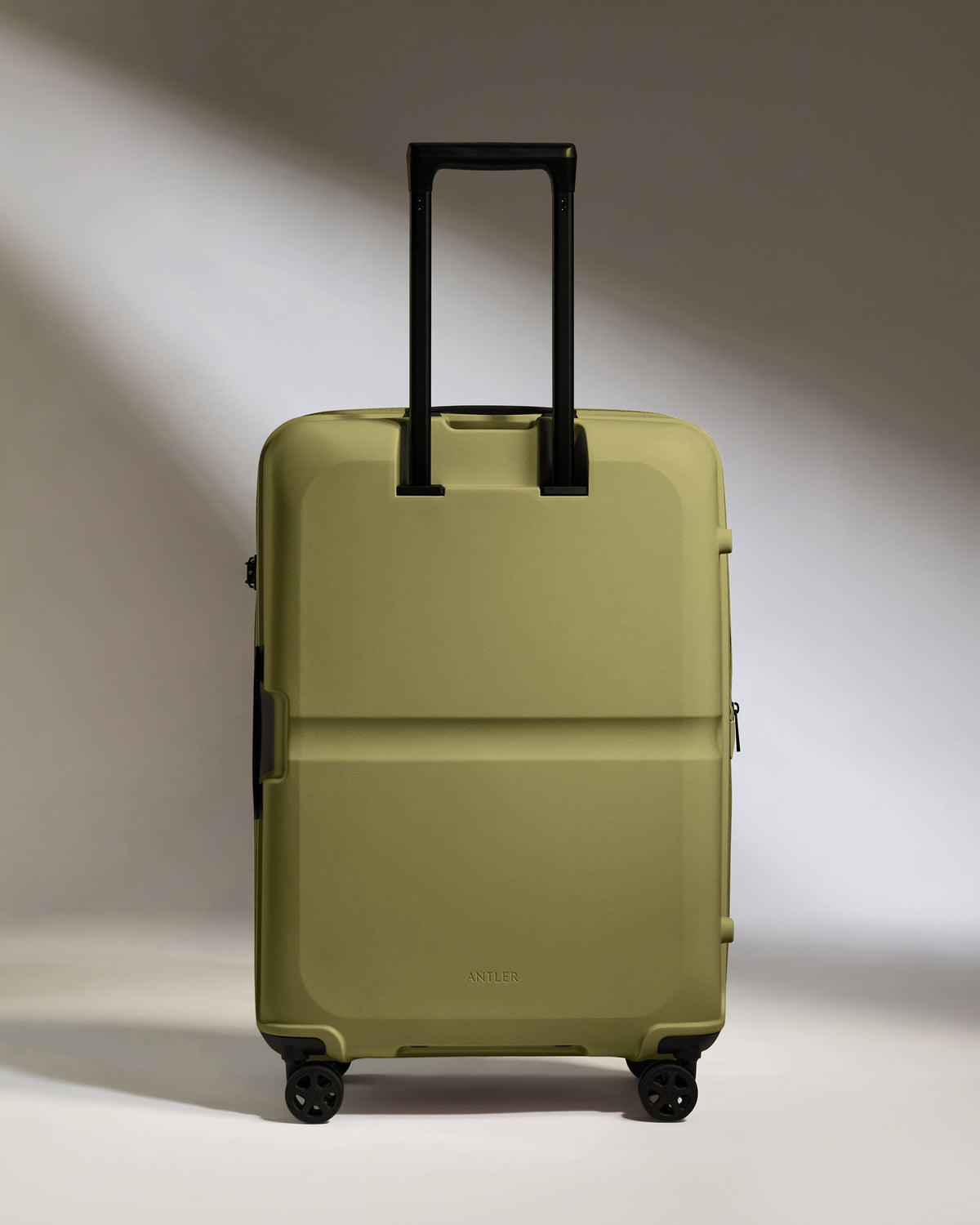 a green suitcase with black handles