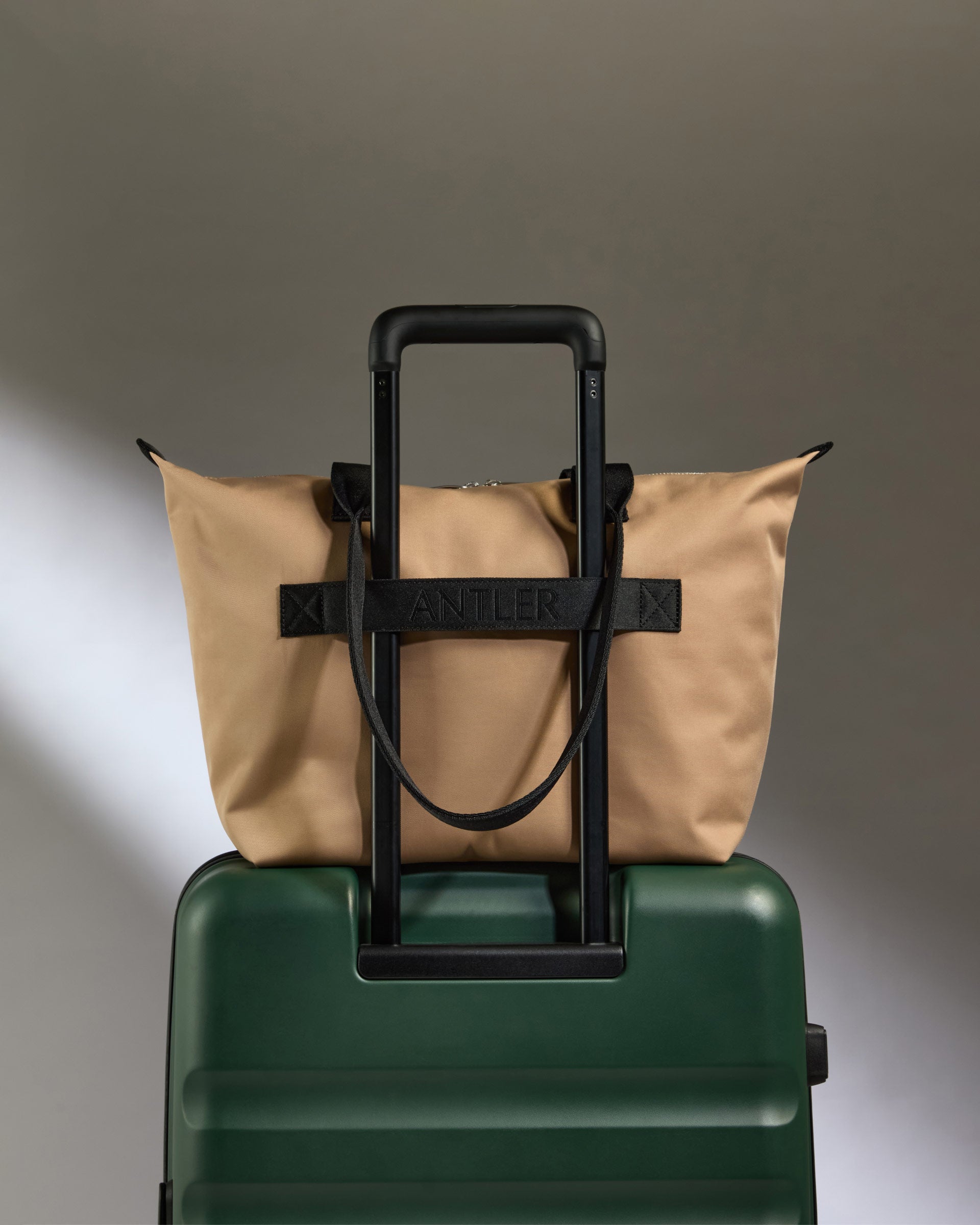 a bag on top of a green suitcase