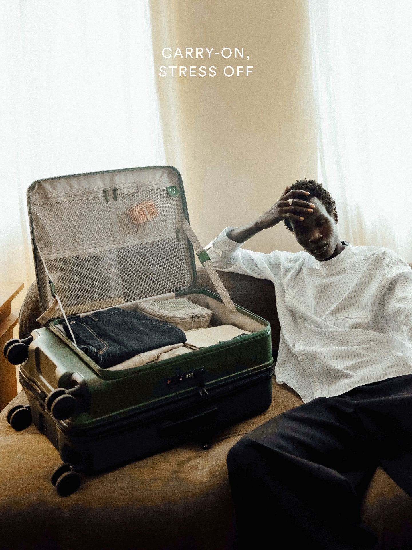 a man sitting on a couch with a suitcase