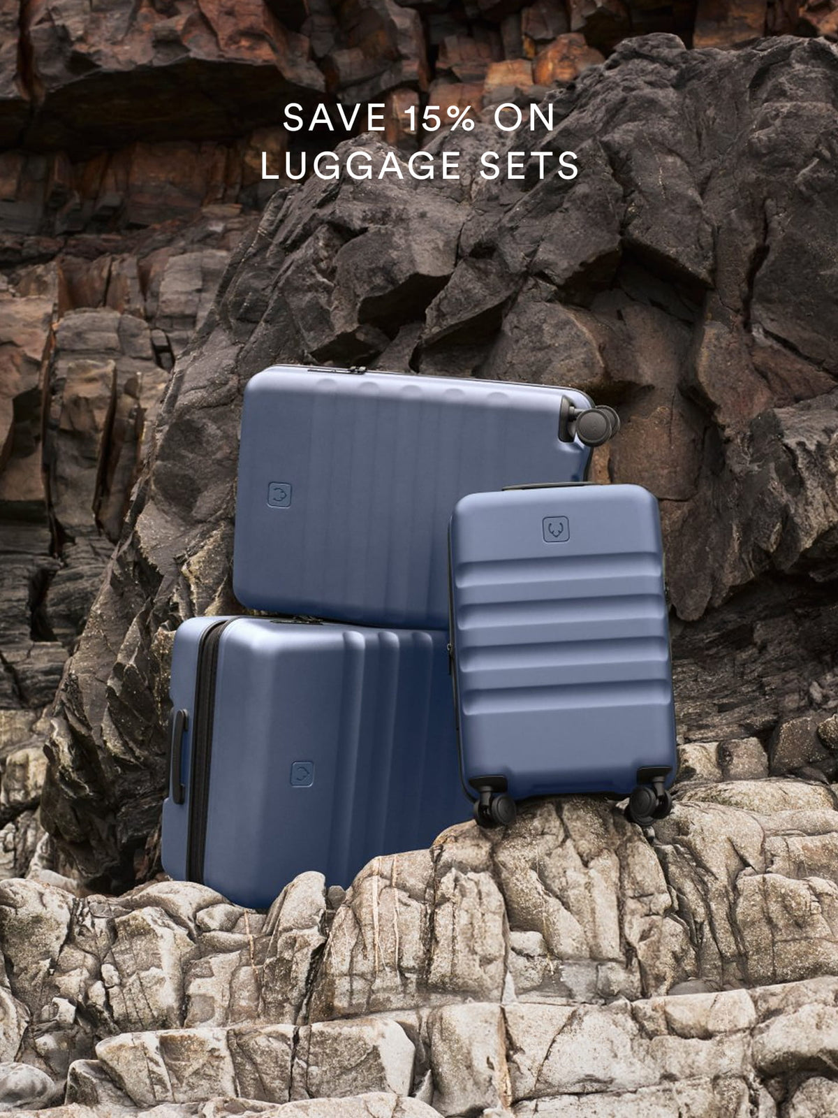 a group of luggage sets on a rocky surface