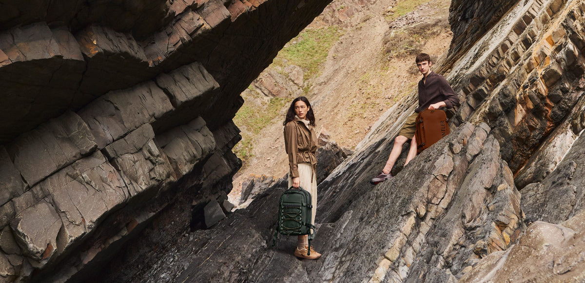 a man and woman standing on a rock