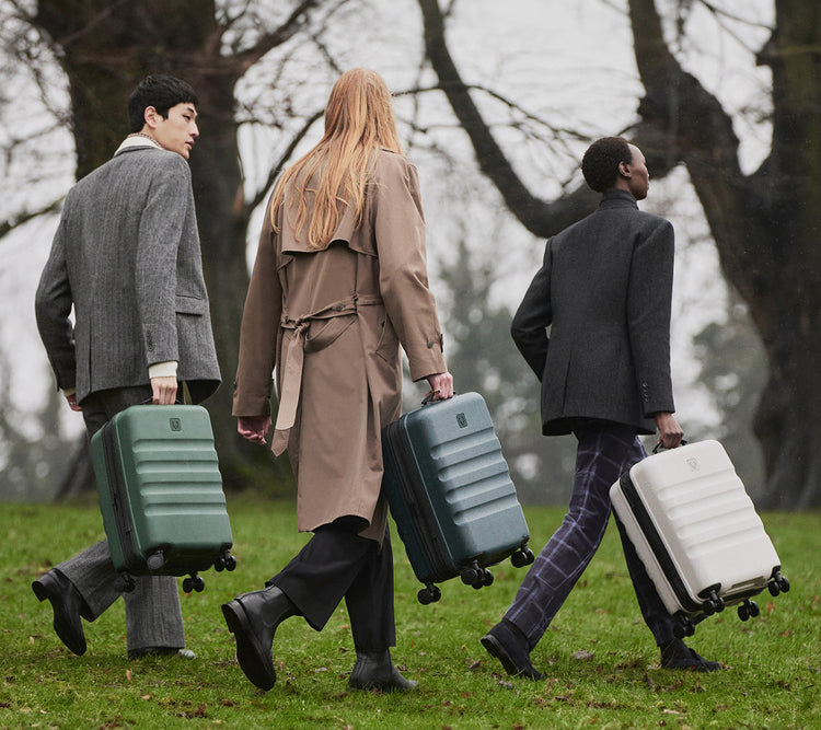a group of people walking with luggage