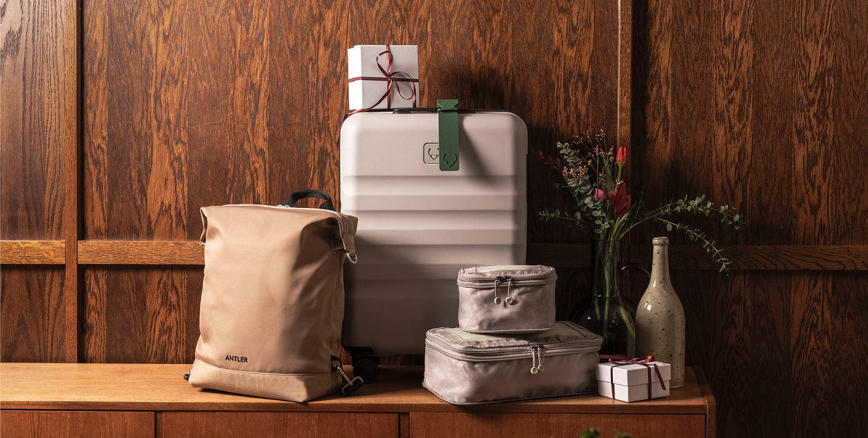 a suitcases and a bag on a shelf