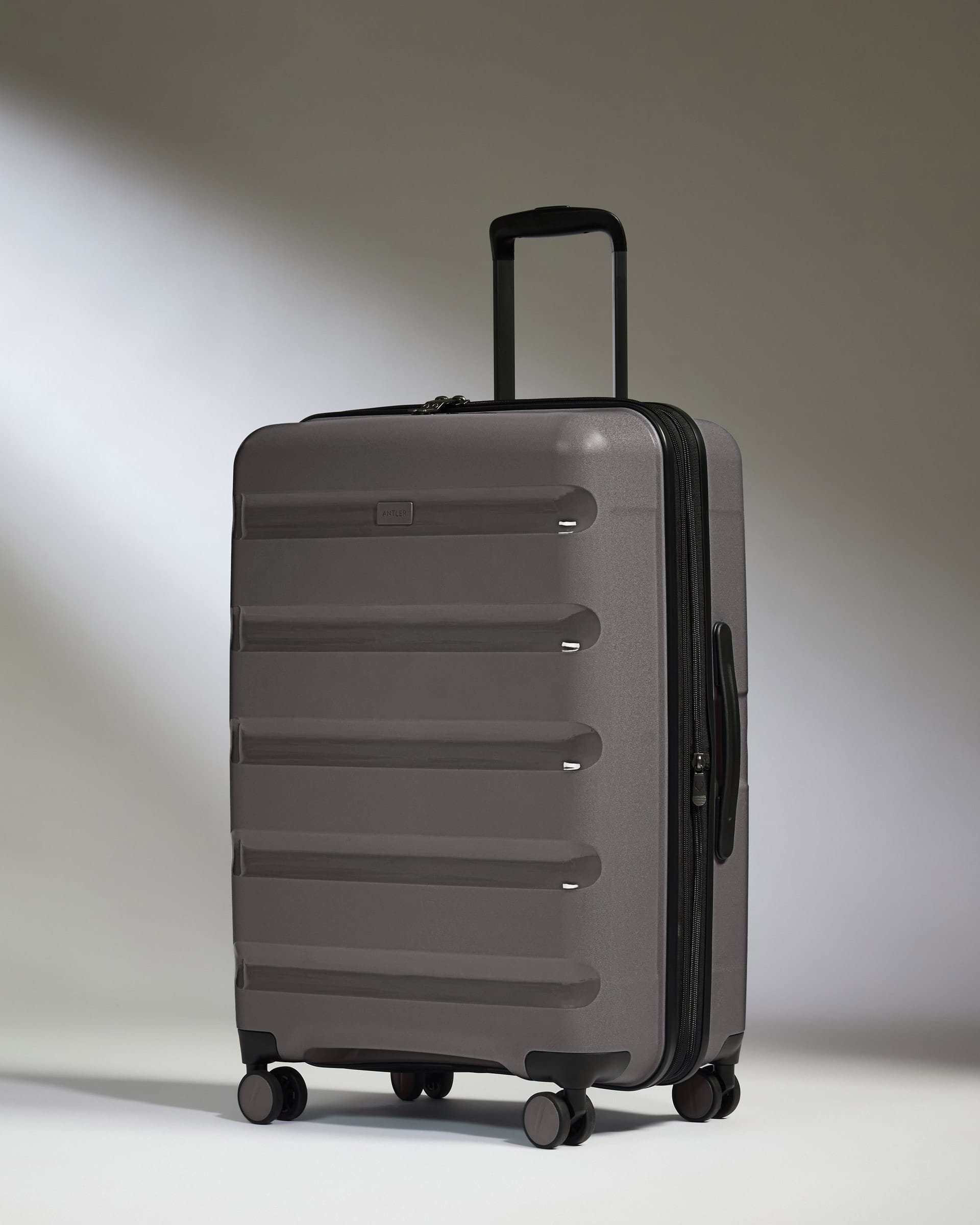 Antler Luggage -  Expandable Medium Suitcase in Gloss Gull Grey - Logo Stripe - Expanding Rollercase | Medium 4W Expandable Medium Suitcase in Gloss Gull Grey - Logo Stripe
