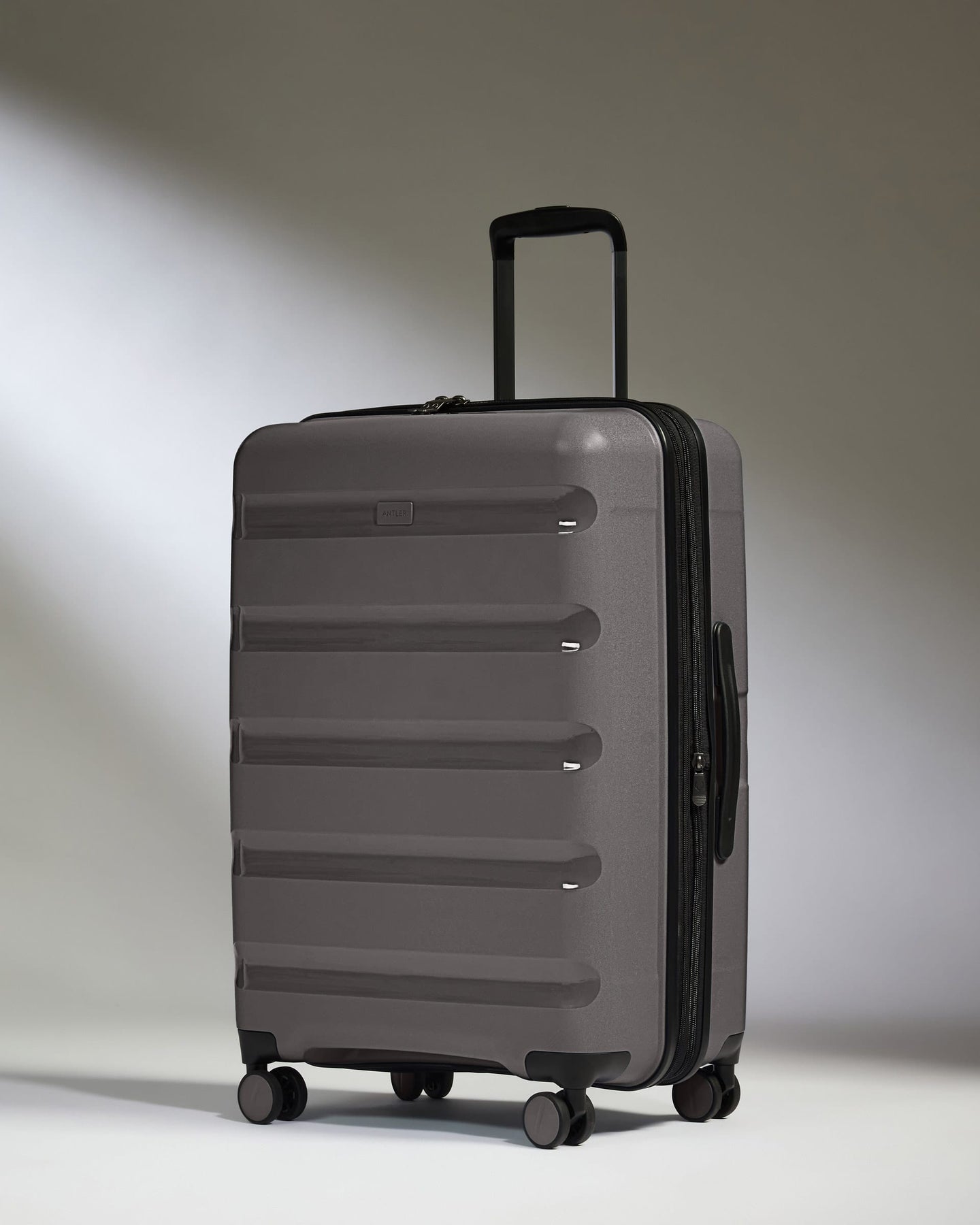Antler Luggage -  Expandable Medium Suitcase in Gloss Gull Grey - Logo Stripe - Expanding Rollercase | Medium 4W Expandable Medium Suitcase in Gloss Gull Grey - Logo Stripe