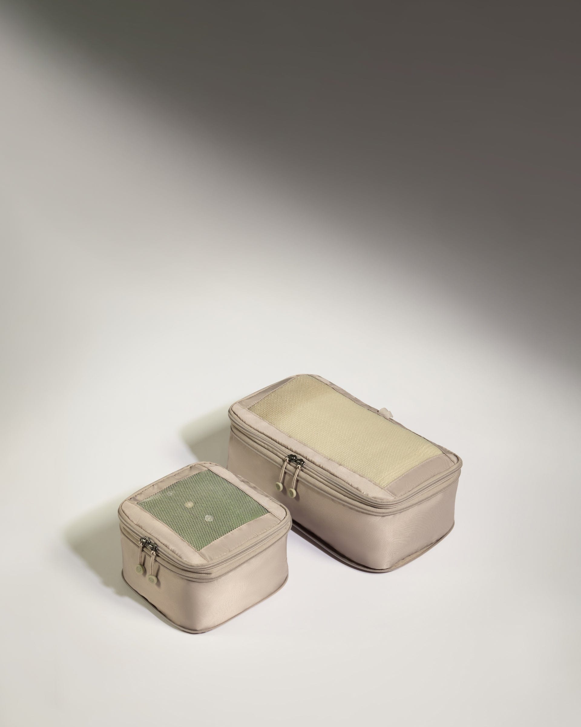 two small bags on a white surface